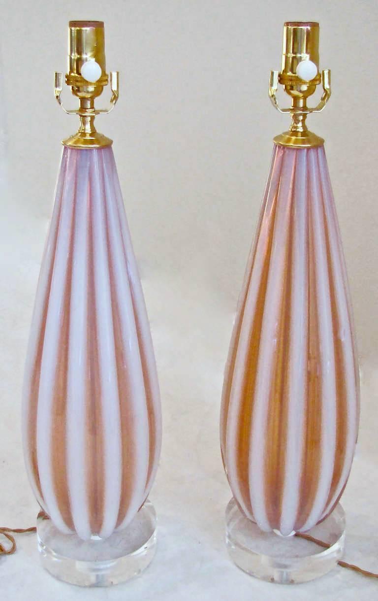 Outstanding pair of thick ribbed hand blown Murano glass table lamps by Fratelli Toso. The opalescent color is combination of opaque striped ribs alternating with salmon/coral with subtle hint of amber and blue. Mounted on custom acrylic bases,