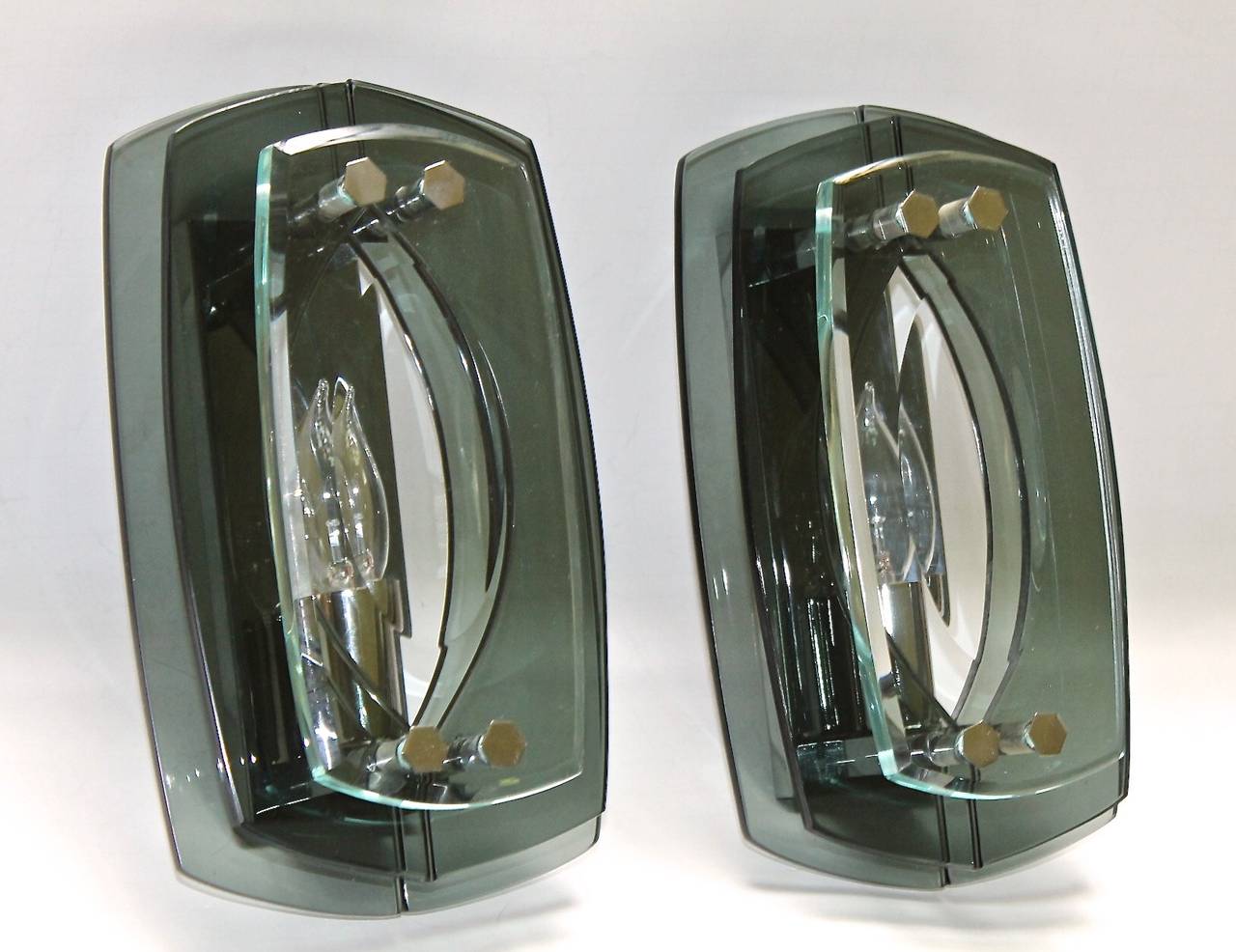 Pair of sconces in the style of Fontana Arte, translucent shades of greenish color glass with chrome-plated fittings, takes one 40-watt bulb, newly wired.