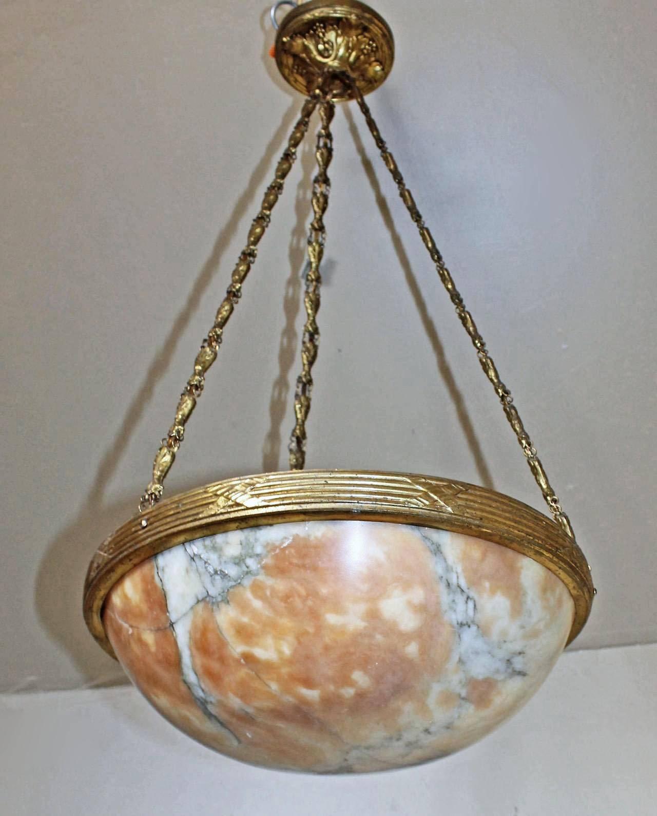 French alabaster chandelier or pendant with brass patinated fittings in the Louis XVl style with rich amber coloring and detailed veining. Fixture is newly wired for the US and uses 3 - 40 watt candelabra base bulbs.

14