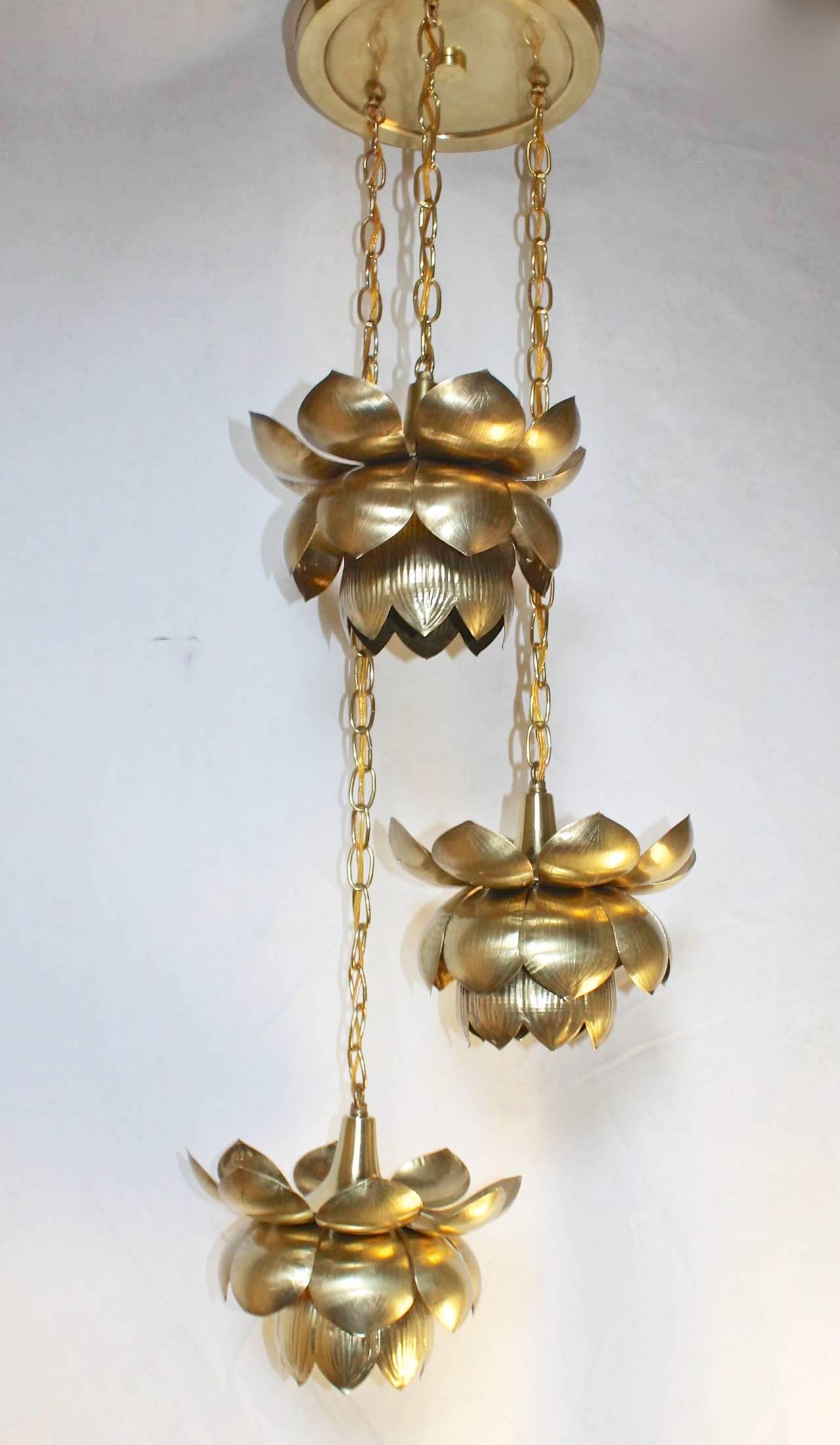 Three brass lotus light chandelier imported by The Feldman Company, Los Angeles. Newly rewired. Dimension: Each lotus 11" wide x 8" tall. Upon request we can separate the 3 lotus lights to hang with their own ceiling cap.