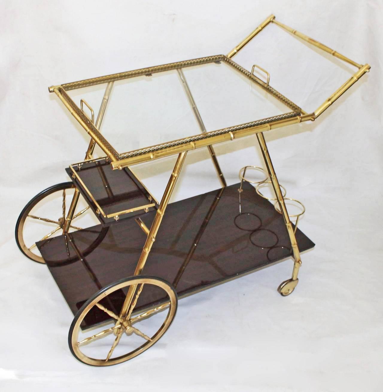 Italian faux bamboo brass 3 tier bar cart. Top removable tray has an inset glass shelf.  Bottom tiers in dark mahogany with brass rail and bottle holder. Beautiful vintage condition.