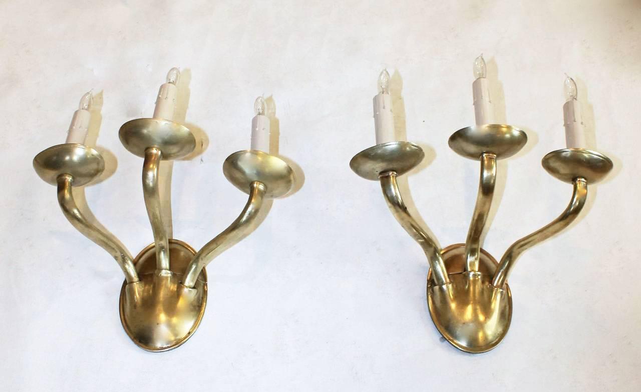 Pair of large and heavy solid brass 3 arm sconces in the Arts & Crafts style by EF Caldwell, New York. Each sconce is stamped twice with the Caldwell 