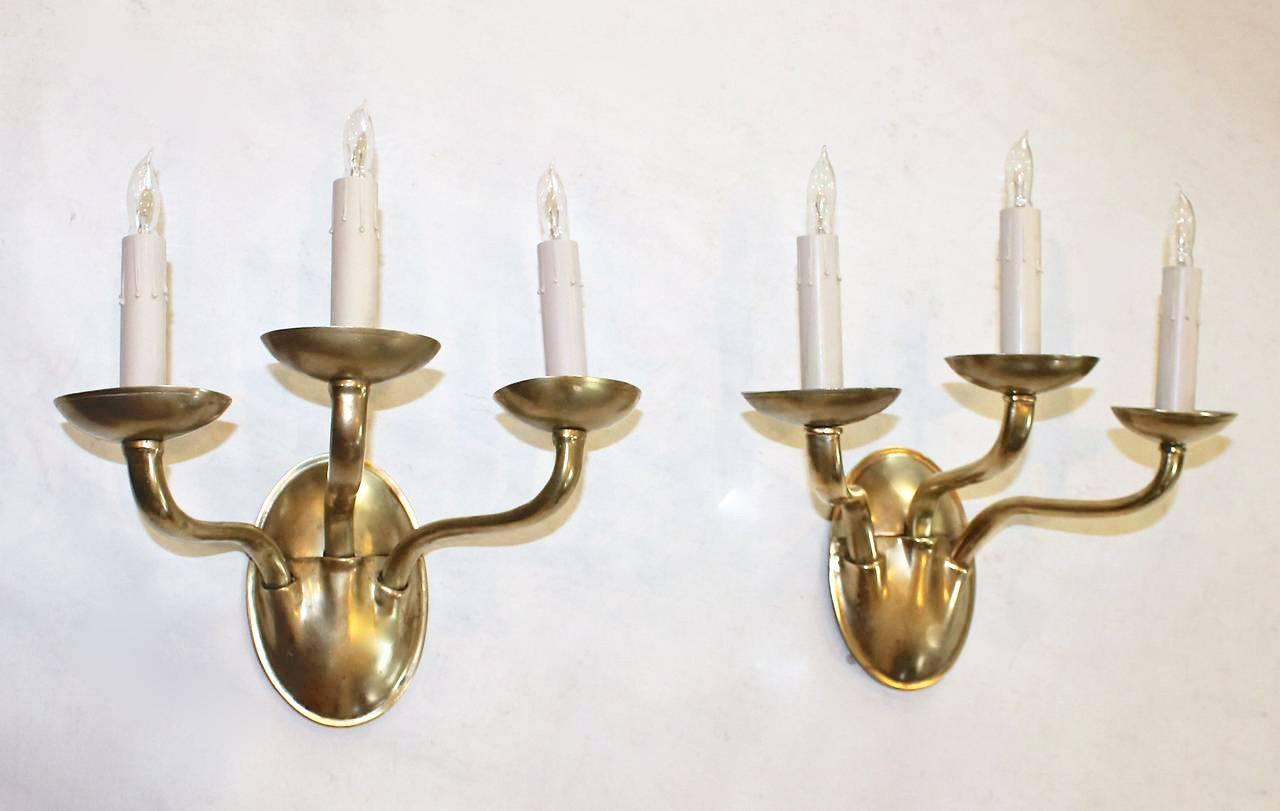 Early 20th Century Pair of EF Caldwell Arts and Crafts, Three-Arm Brass Wall Sconces
