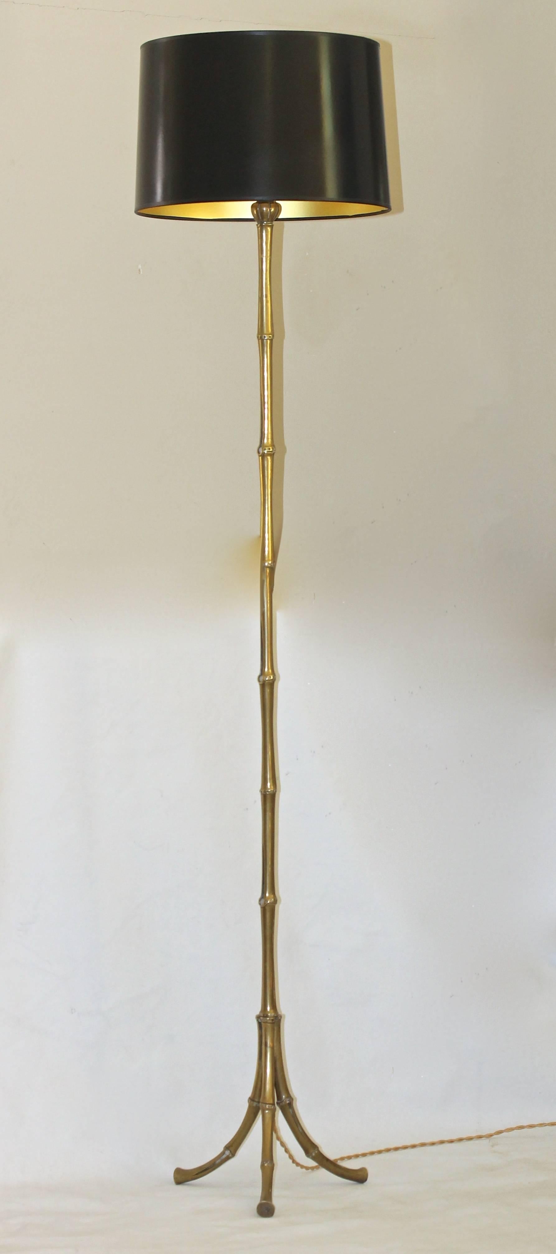 French Maison Bagues solid bronze faux bamboo floor lamp resting on tripod legs. Newly wired with a full range dimmer socket and French style rayon covered twisted cord. Uses 1 - 60 watt max 