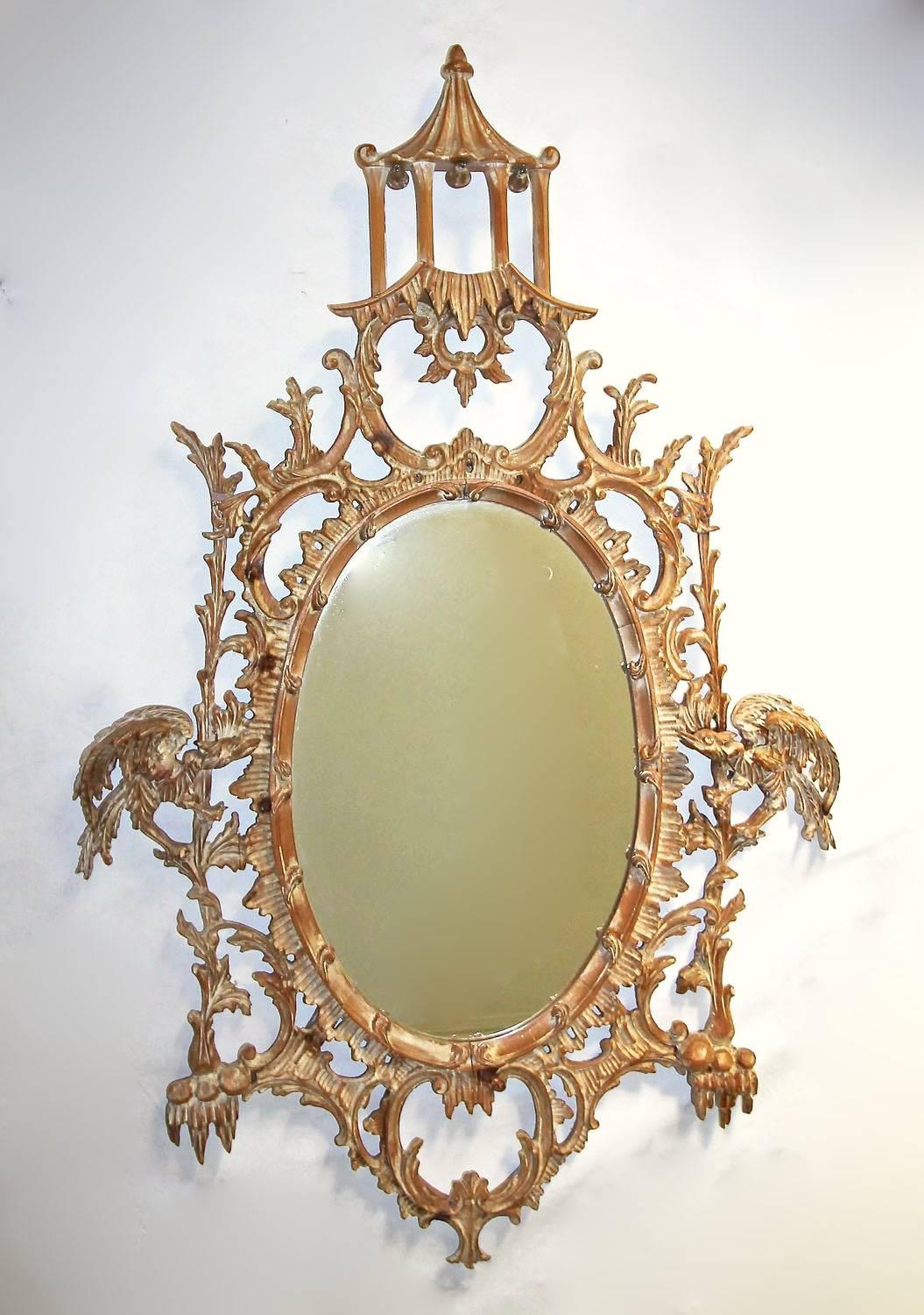 Vintage carved solid wood wall mirror in the Chinese Chippendale style. Nicely carved pagoda motif with bells and two carved ho ho birds. Made in Italy.
