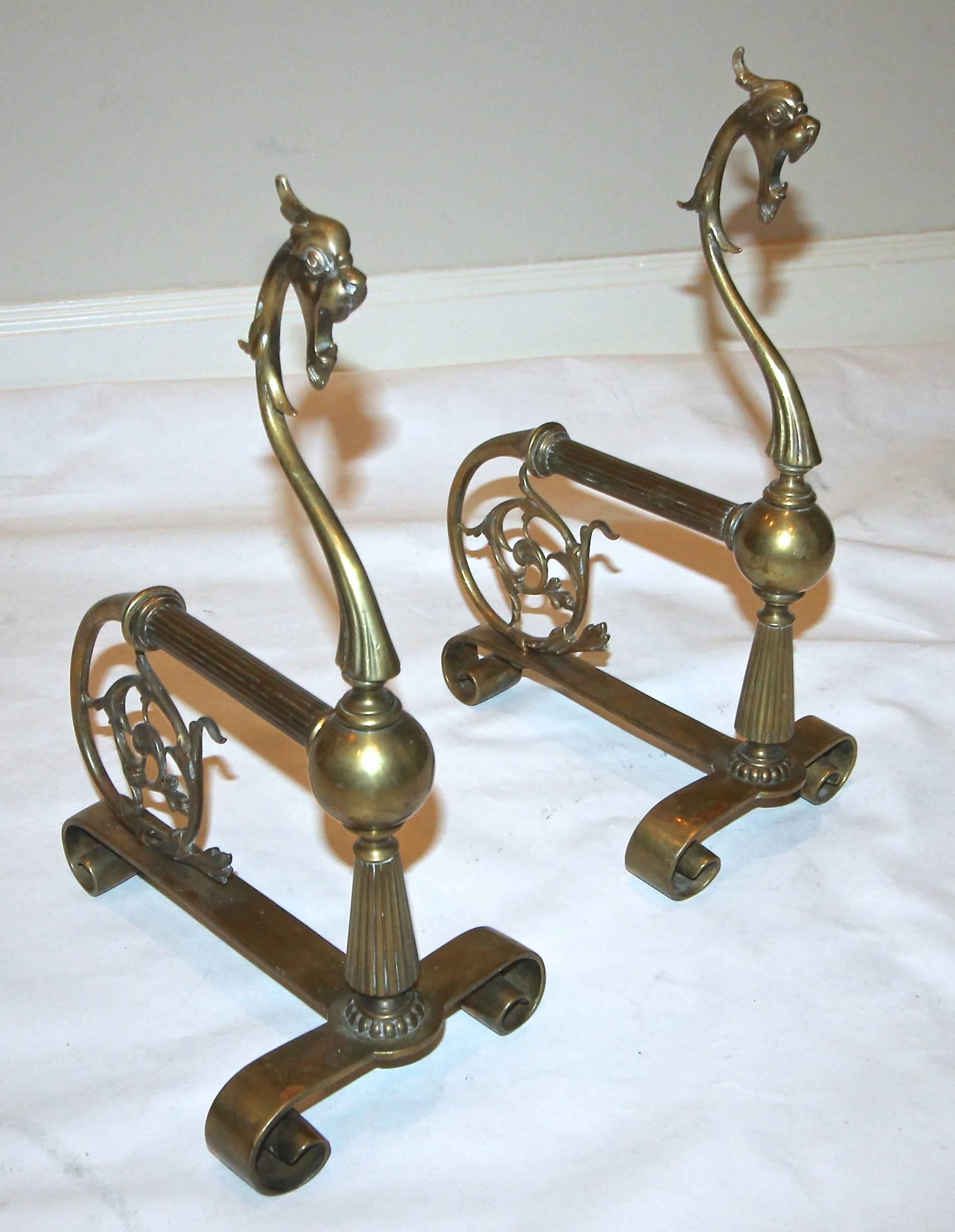 Pair of French brass Gothic style andirons with griffin motif.