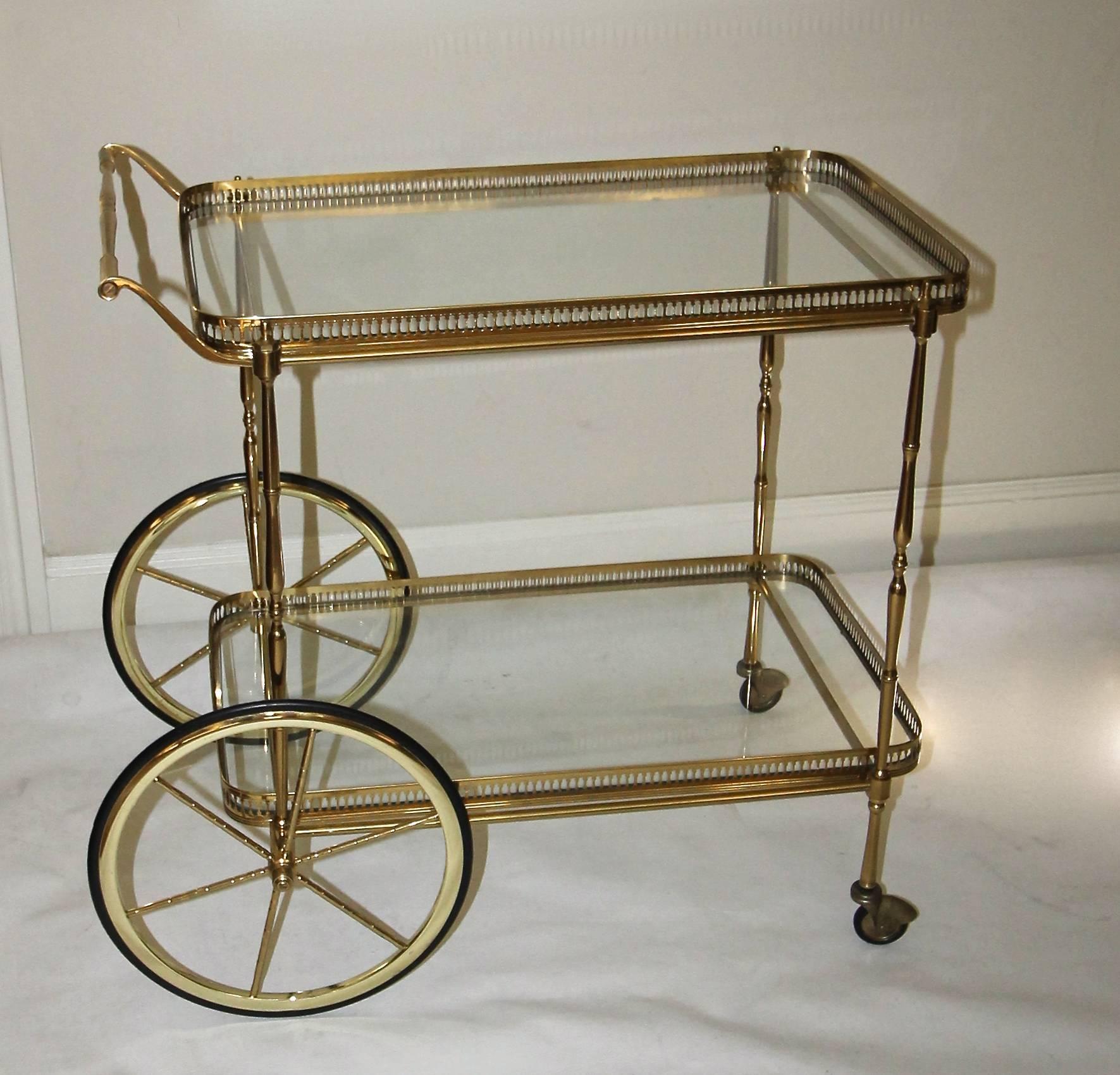 Vintage French brass bar cart with 2 tier glass inset shelves. Overall height to top handle 27.5