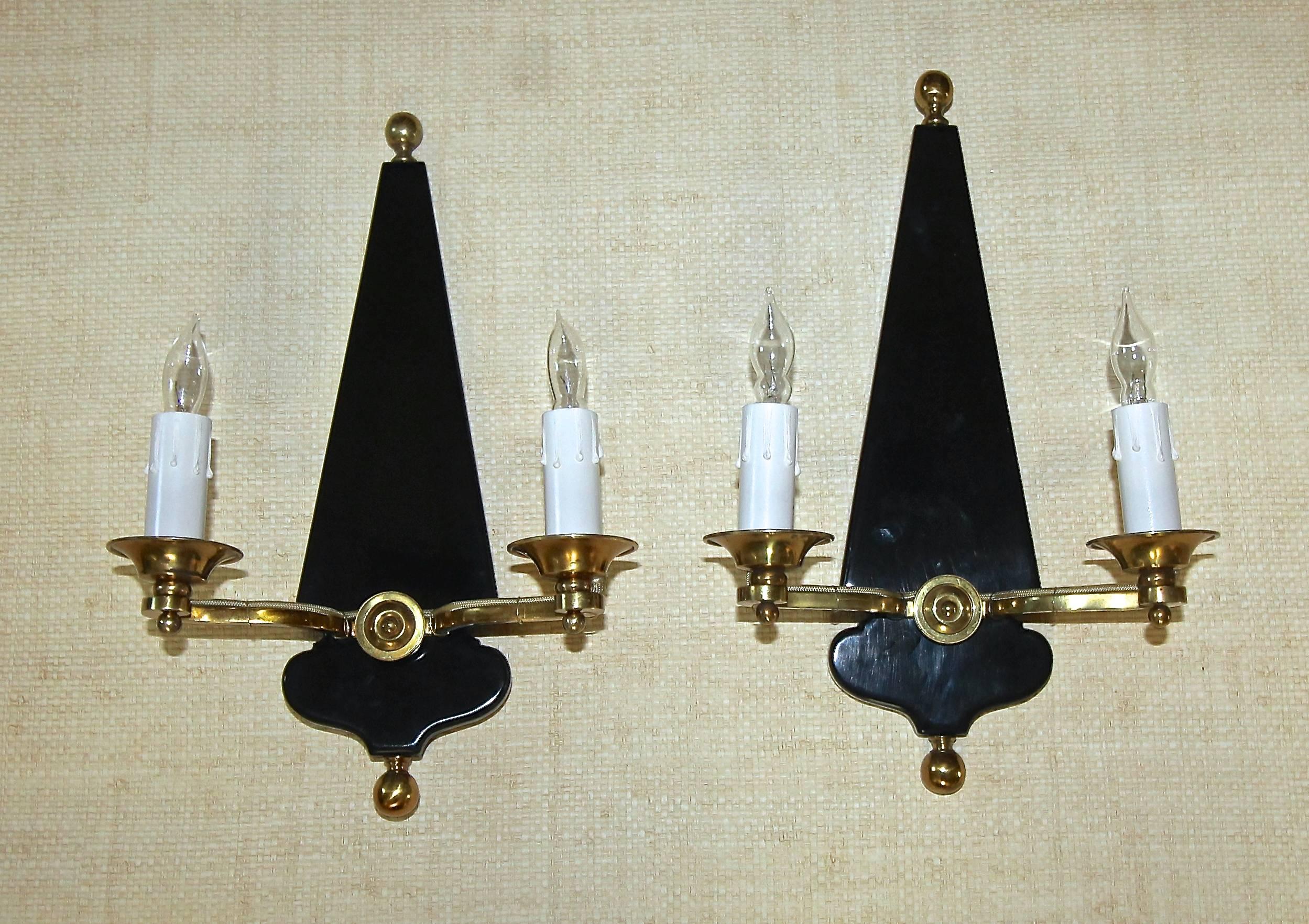 Pair French 2 light black lacquered wood and brass wall sconces in the manner of Maison Jansen. Each takes two 40-watt candelabra size bulbs, newly wired.
