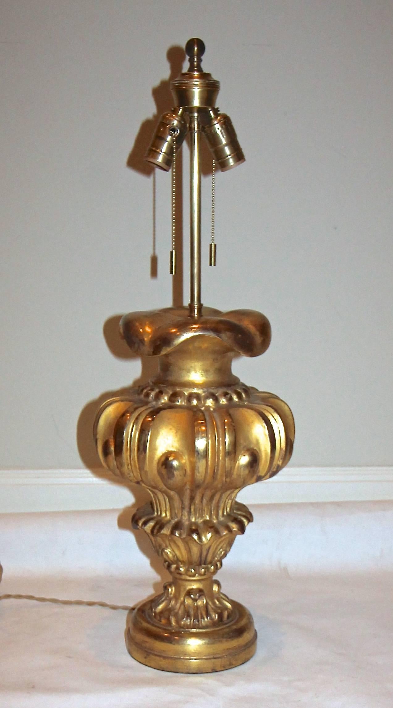 French water gilt carved wood table lamp. Double cluster brass hardware fittings. Newly wired with French style rayon covered cord. Wood portion 17