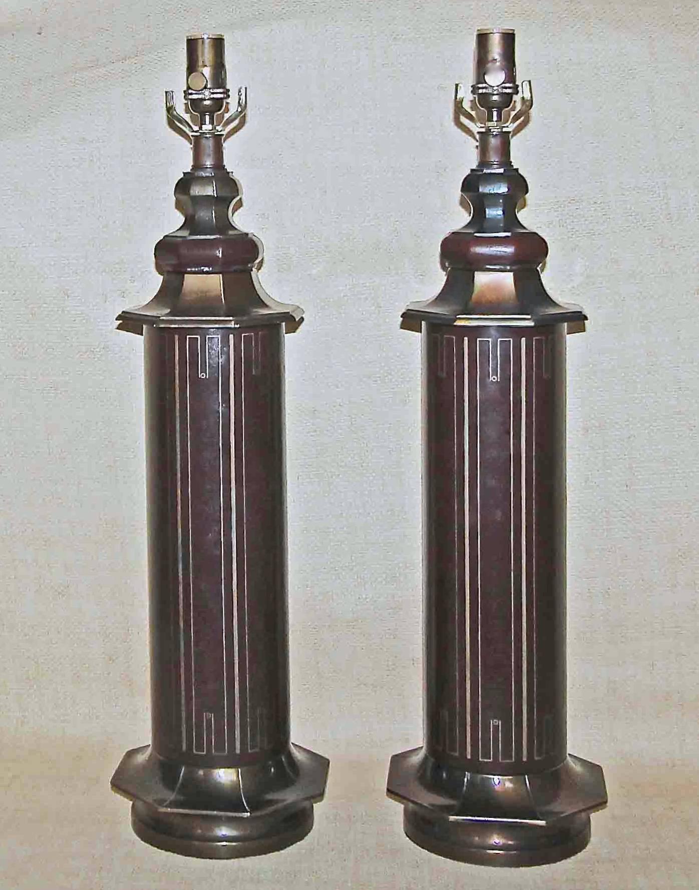 Pair of vintage tooled brown leather table lamps with antiqued bronze finish fittings in the style of Tommi Parzinger. Newly wired.