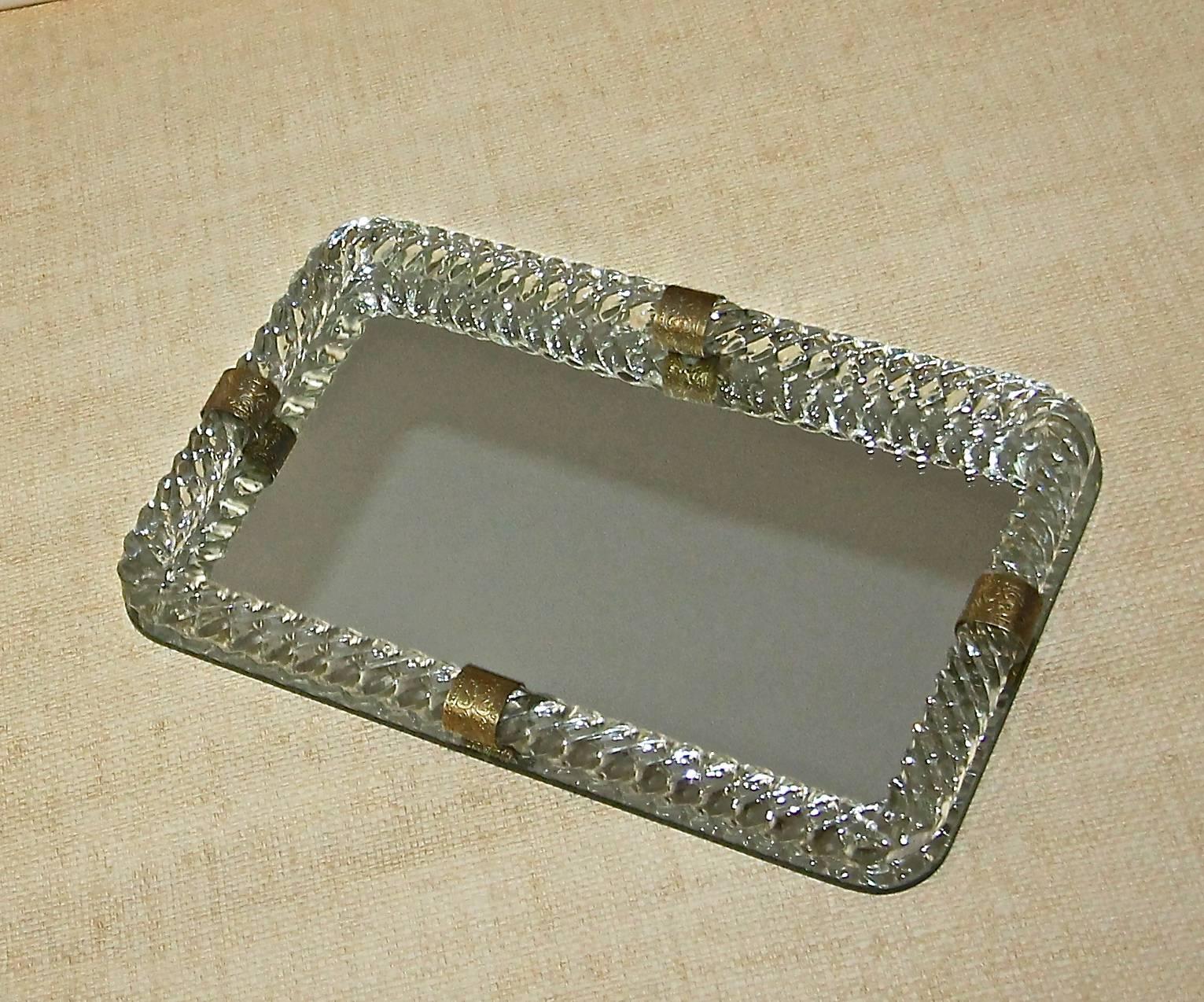 Italian mirrored glass vanity tray surmounted by thick twisted mouth blown glass with decorative brass straps.