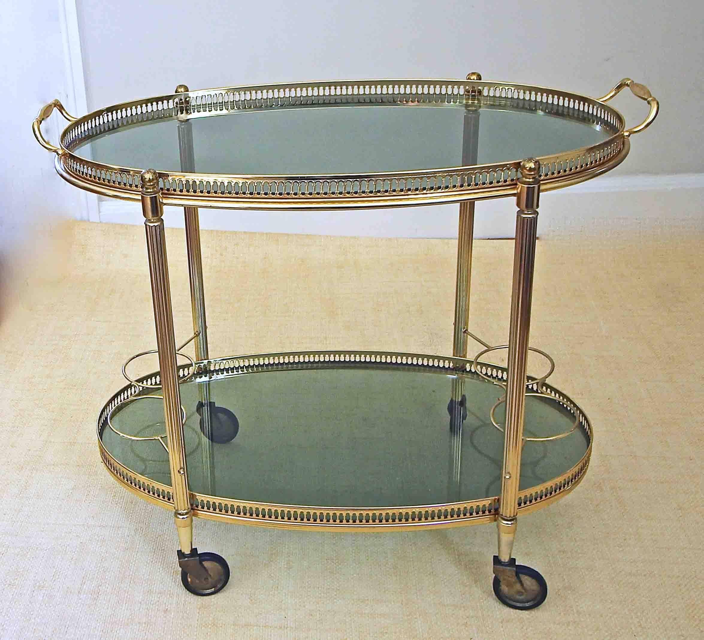 Diminutive brass-plated bar cart with removable glass tray, inset tinted glass resting on caster wheels. (Will ship partially unassembled.)