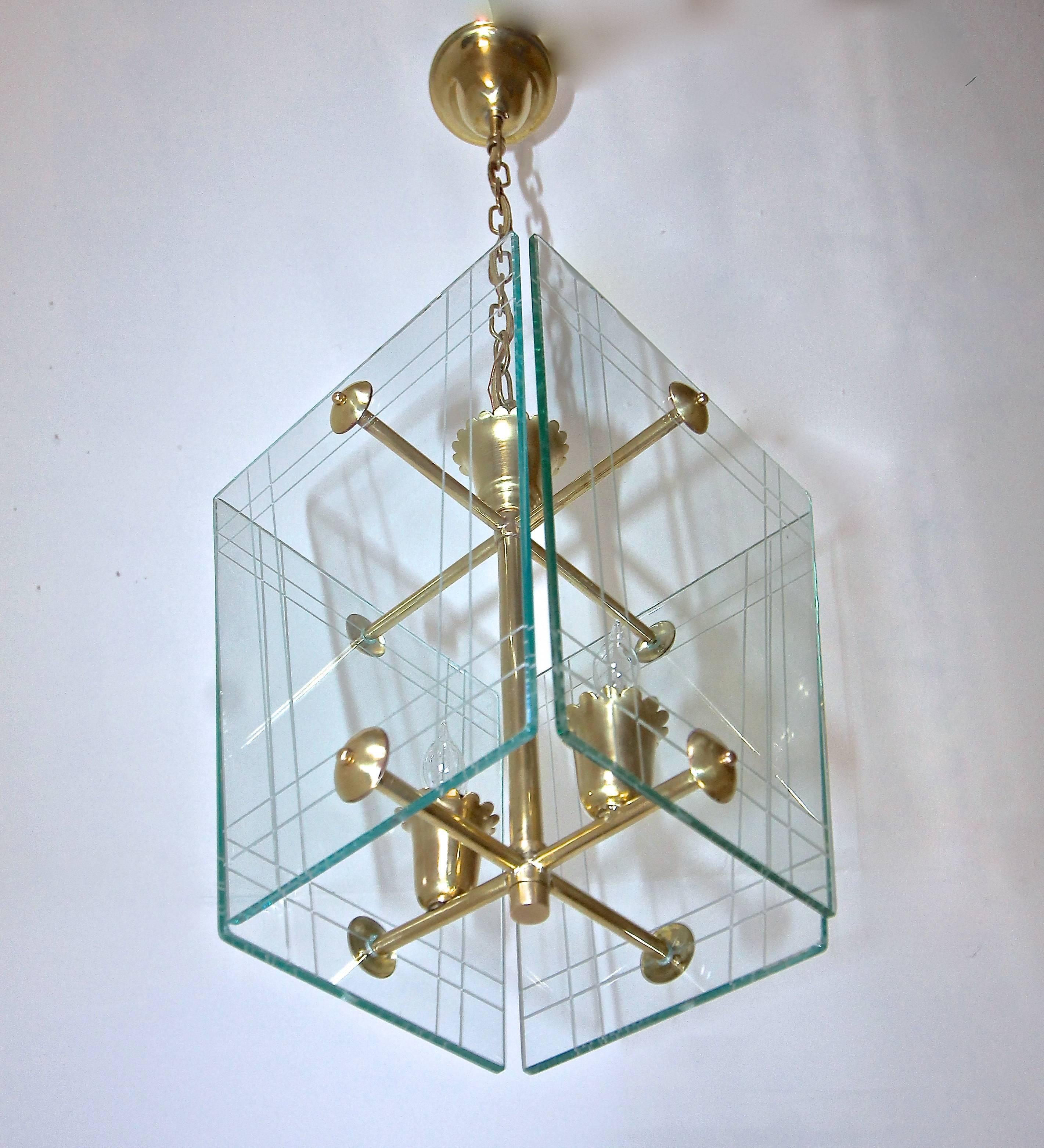 Italian moderne hall or entry pendant light in the manner of Pietro Chiesa for Fontana Arte. Etched glass panels are
suspended on brass frame. Fixture uses 2 - 40 watt max candelabra base bulbs, newly wired. Size of fixture 10