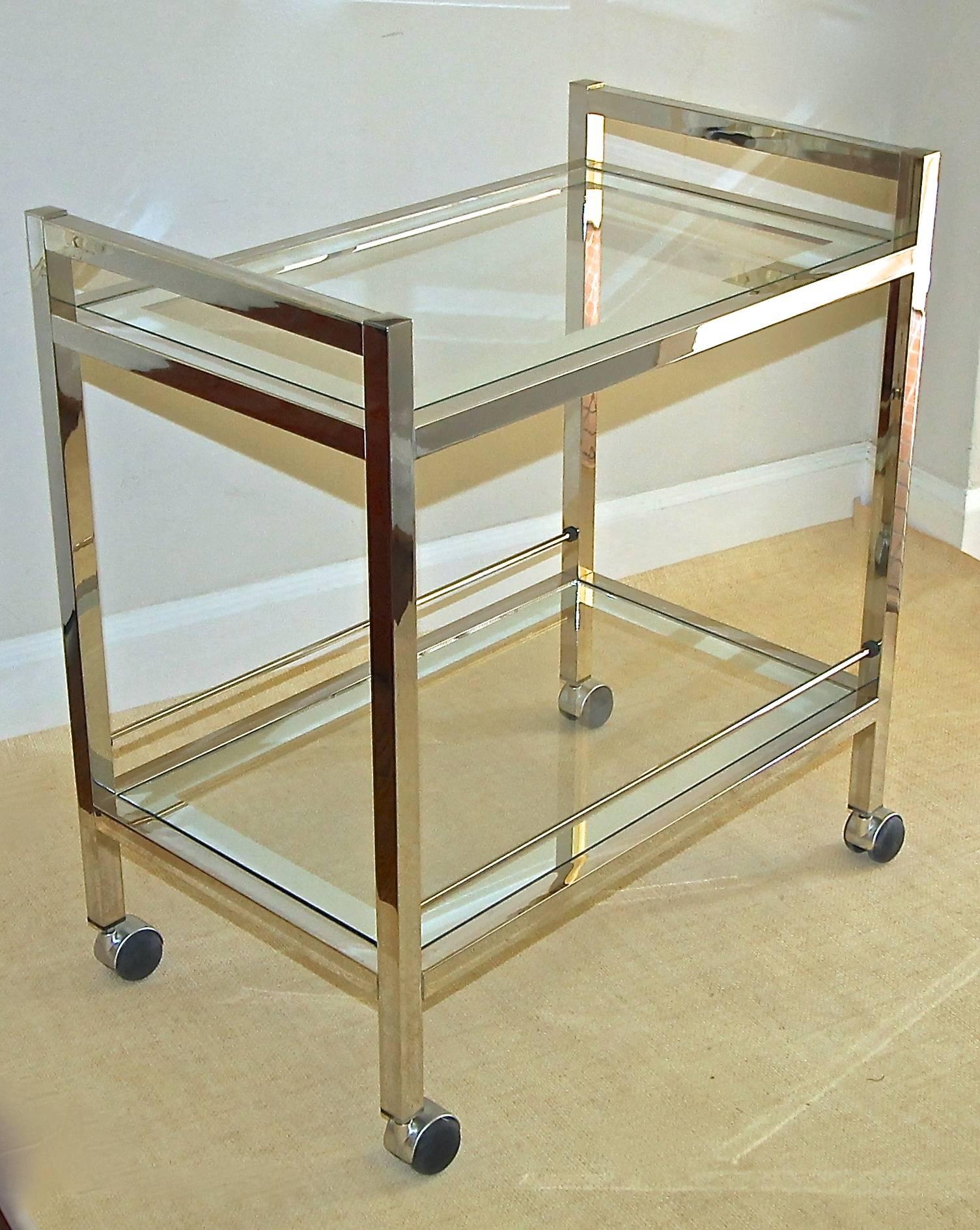 Modern two-tier bar cart with inset glass tops with mirrored edged detail and castor wheels. Height top of handles 29.5