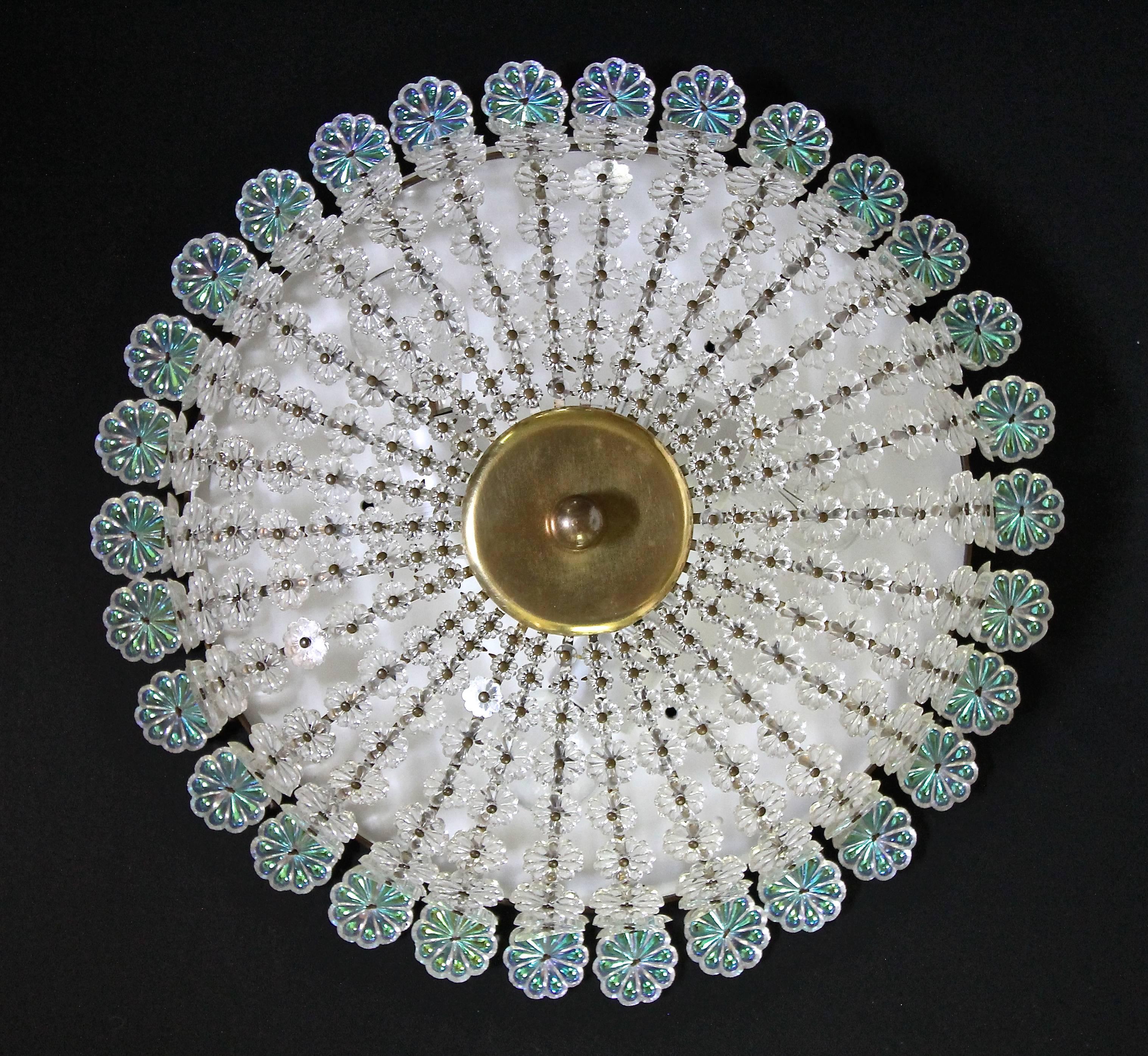 Very rare and beautiful Emil Stejnar flower motif flush mount ceiling light. Surrounding the perimeter of the fixture are larger size opalescent glass flowers or florets, cascading down on brass stems are rows of clear glass florets each decreasing