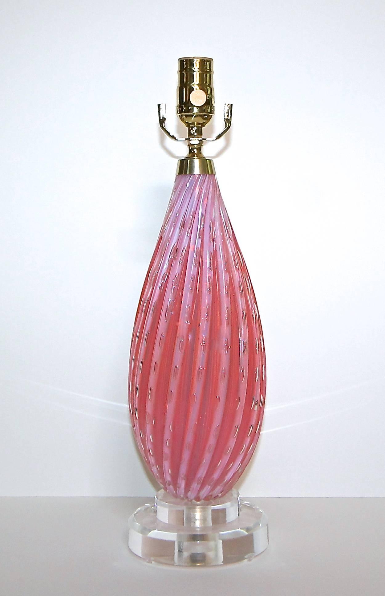 A smaller scale Italian Murano glass table lamp in vibrant pink with thick swirls and controlled bubbles. Glass sits on top of custom acrylic base and is newly wired for US with new brass hardware and French style rayon covered twisted cord. Shade