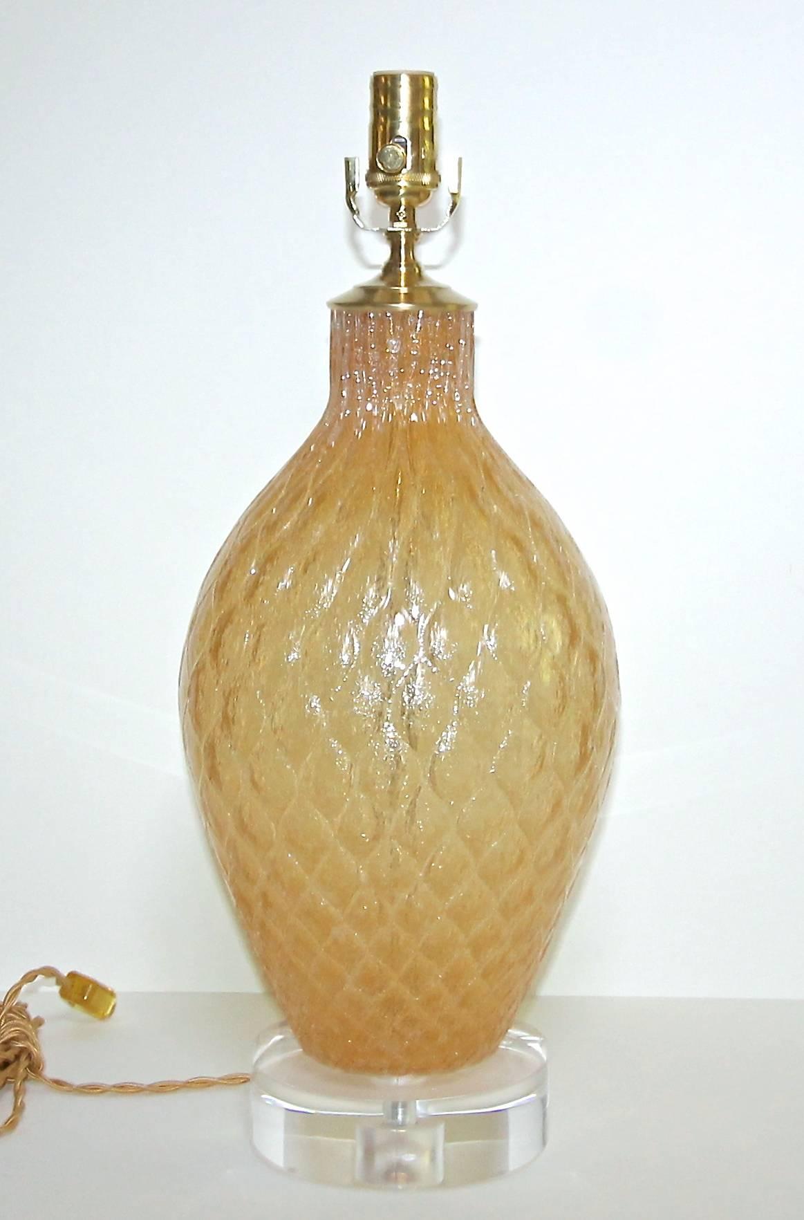 Italian Murano handblown amber color glass table lamp by Galliano Ferro. Glass has a textured diamond pattern on the exterior and is created with the pulegoso technique, filled with tiny bubbles. Mounted on new custom acrylic base, newly wired for