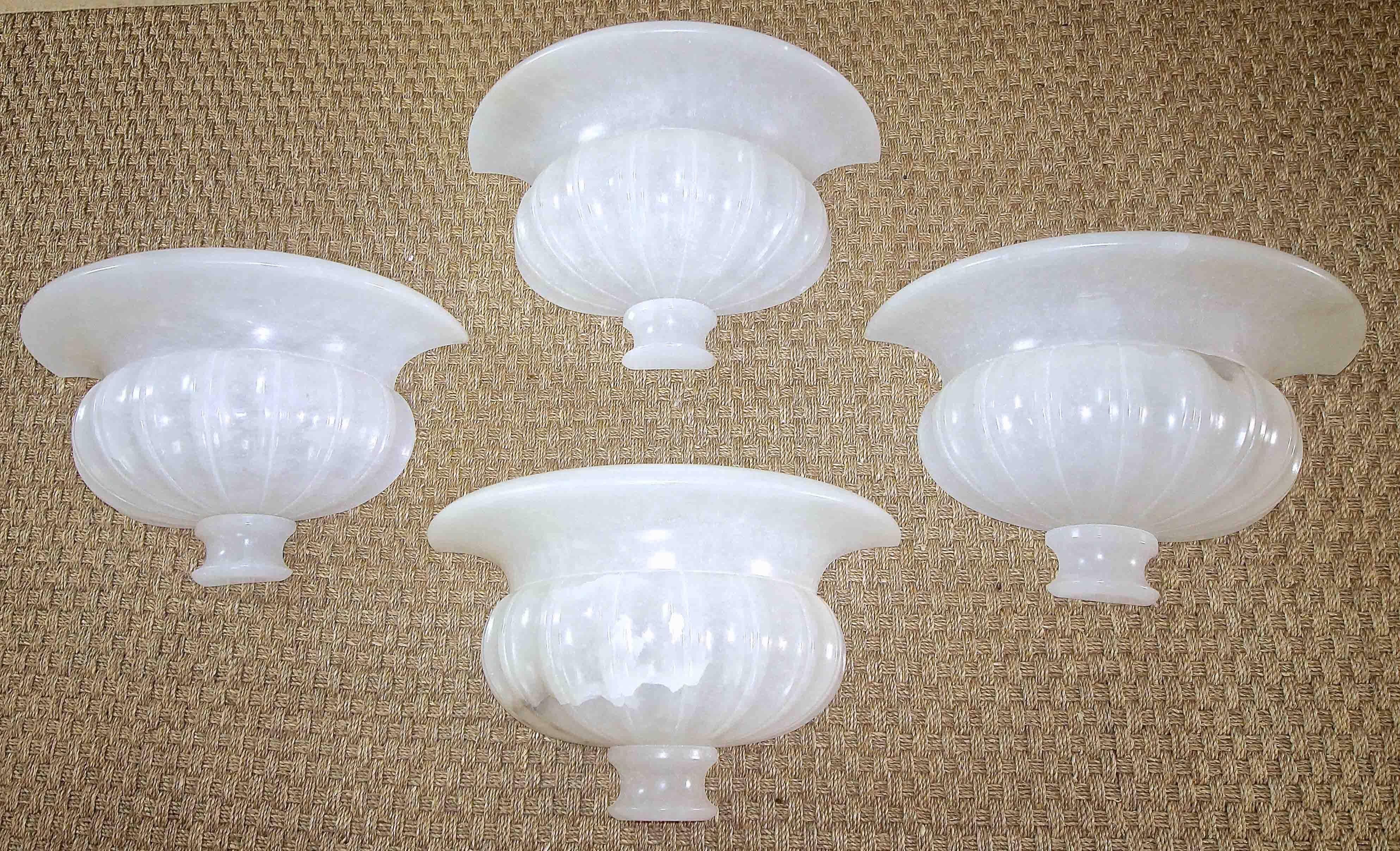 Set of four (4) large alabaster wall sconces in a neoclassic urn form. Hand carved in Italy. Newly wired for US. 

Priced by the pair. Available for purchase by the pair or the complete set of four sconces (two pairs).

19.75