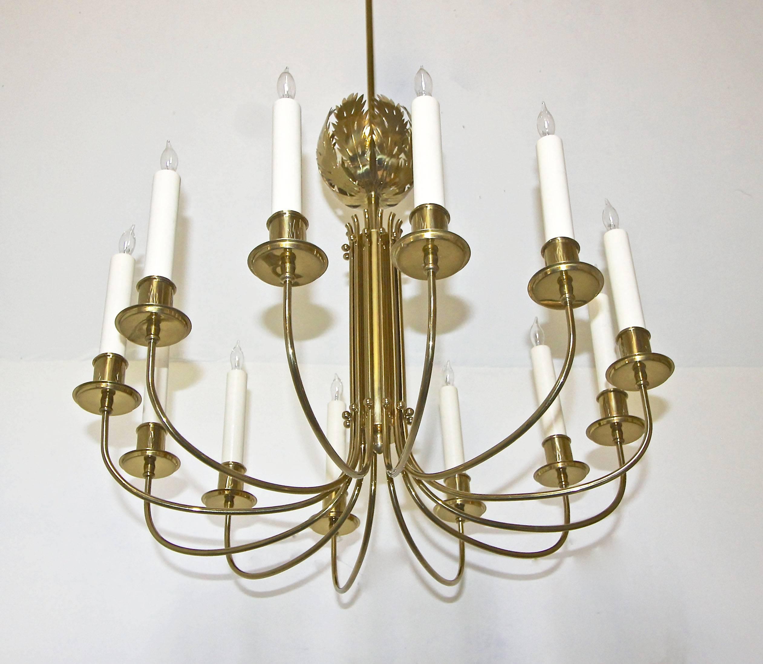 A very rare solid brass chandelier designed by Tommi Parzinger for Parzinger Originals and handcrafted by Fliex Balbo. Solid brass construction with beautiful acanthus leaf motif that is repeated on each candle cup. Newly wired and retaining the