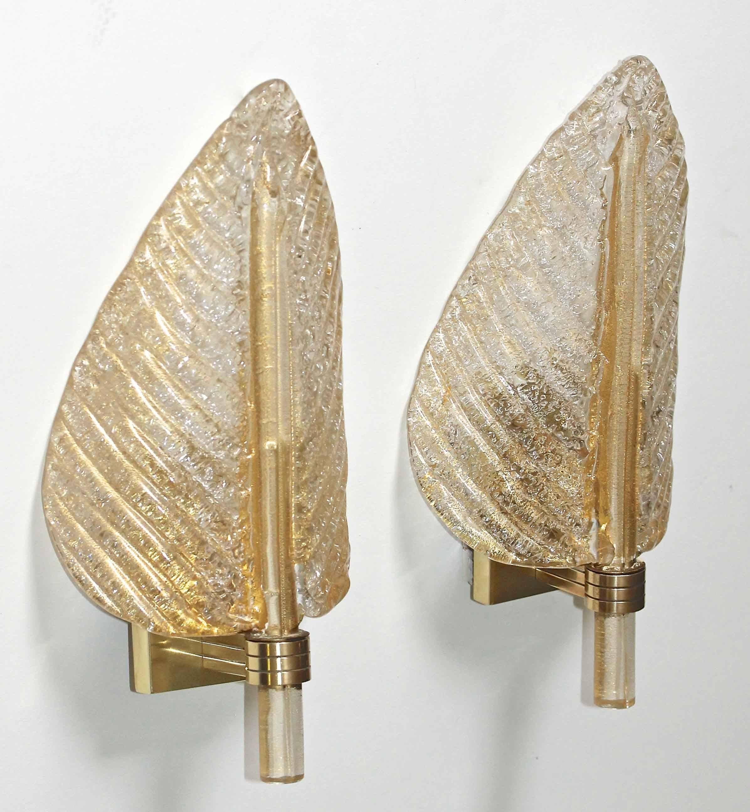 Pair of Murano gold infused glass wall sconces in plume or leaf form manufactured by Barovier & Toso. Reverse side of the glass in the "Rugiadoso" technique with scattered Fine particles of glass which diffuses light to a more even