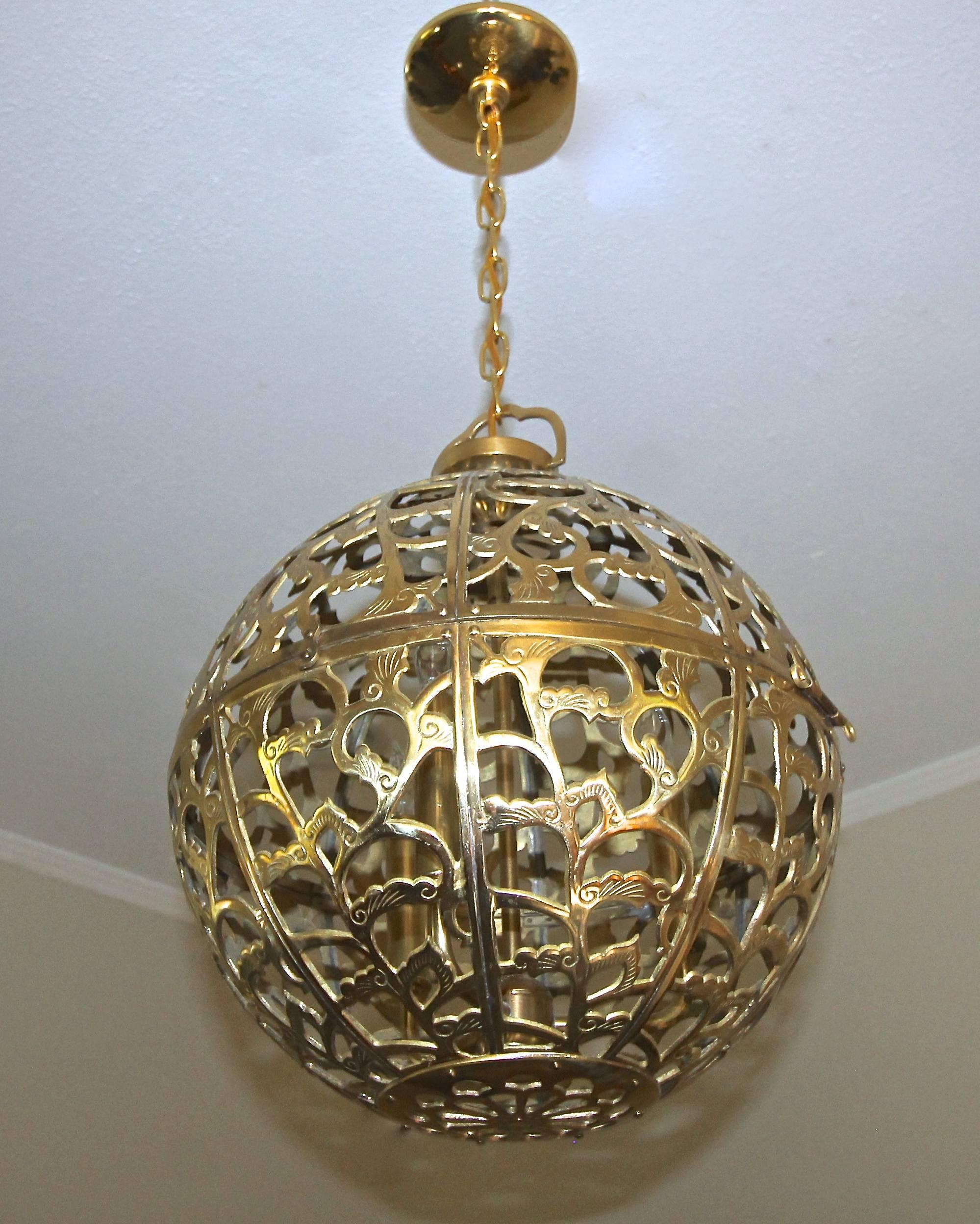 A large and high quality filigree brass ceiling or pendant light with scrolling arabesque patterns. Handcrafted from thick solid brass in Japan in the 1950s, this pendant has been refitted with a custom brass triple light cluster for a more