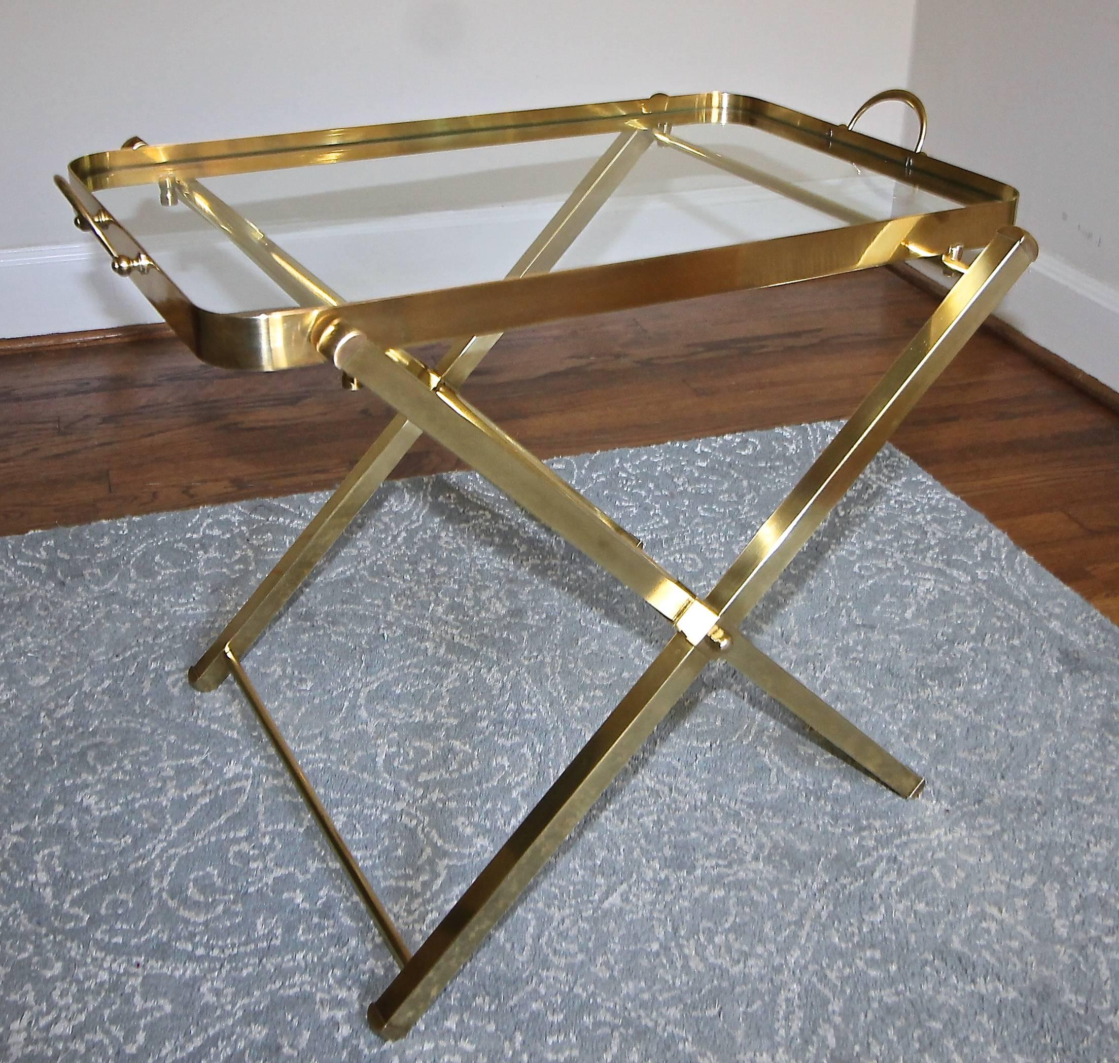 Italian brass folding side or end table with removable glass inset serving tray. X-base folds and can be stored and makes an excellent additional serving table for tight spaces.