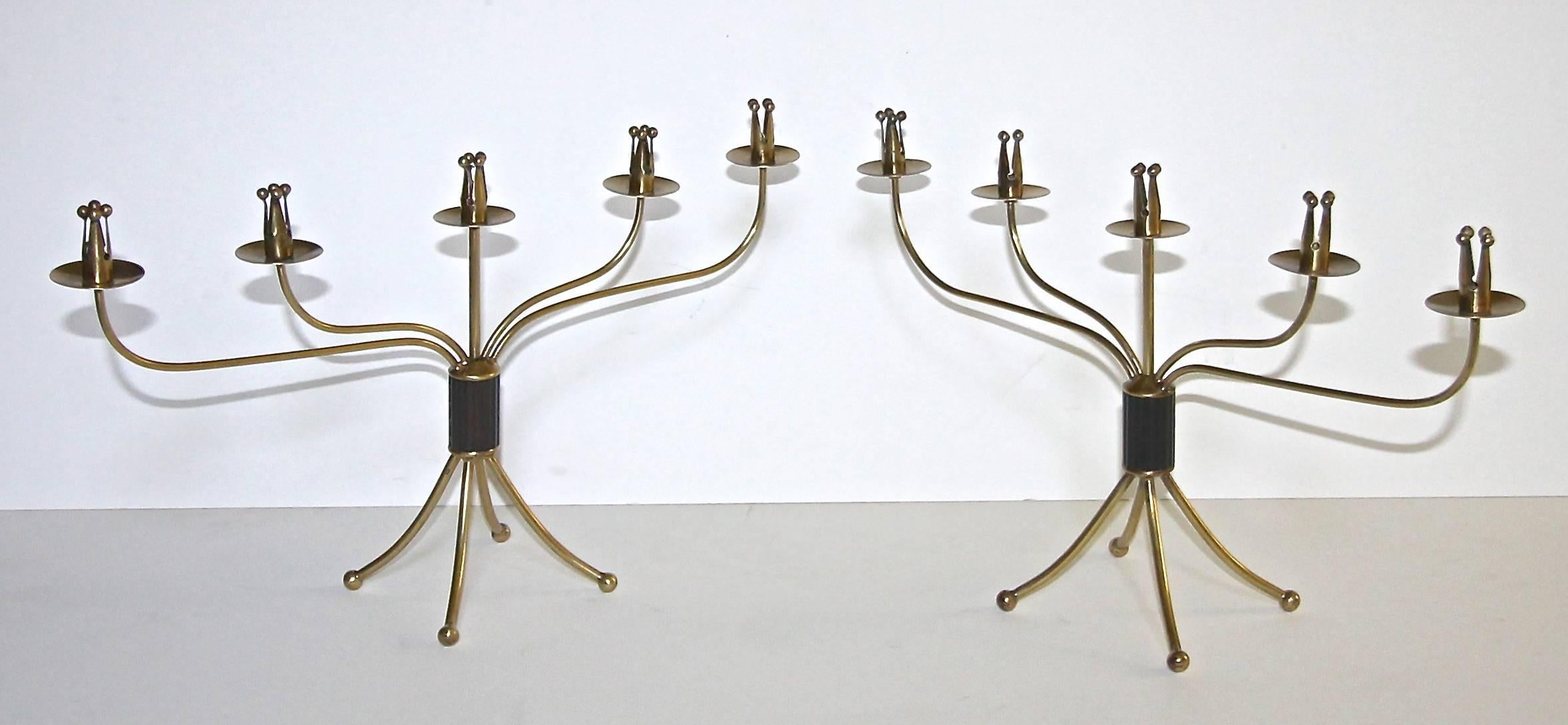 Pair of rare Swedish brass and partially patinated five arm candelabras or candlesticks, stamped Made in Sweden. Nice overall warm patina to brass finish.