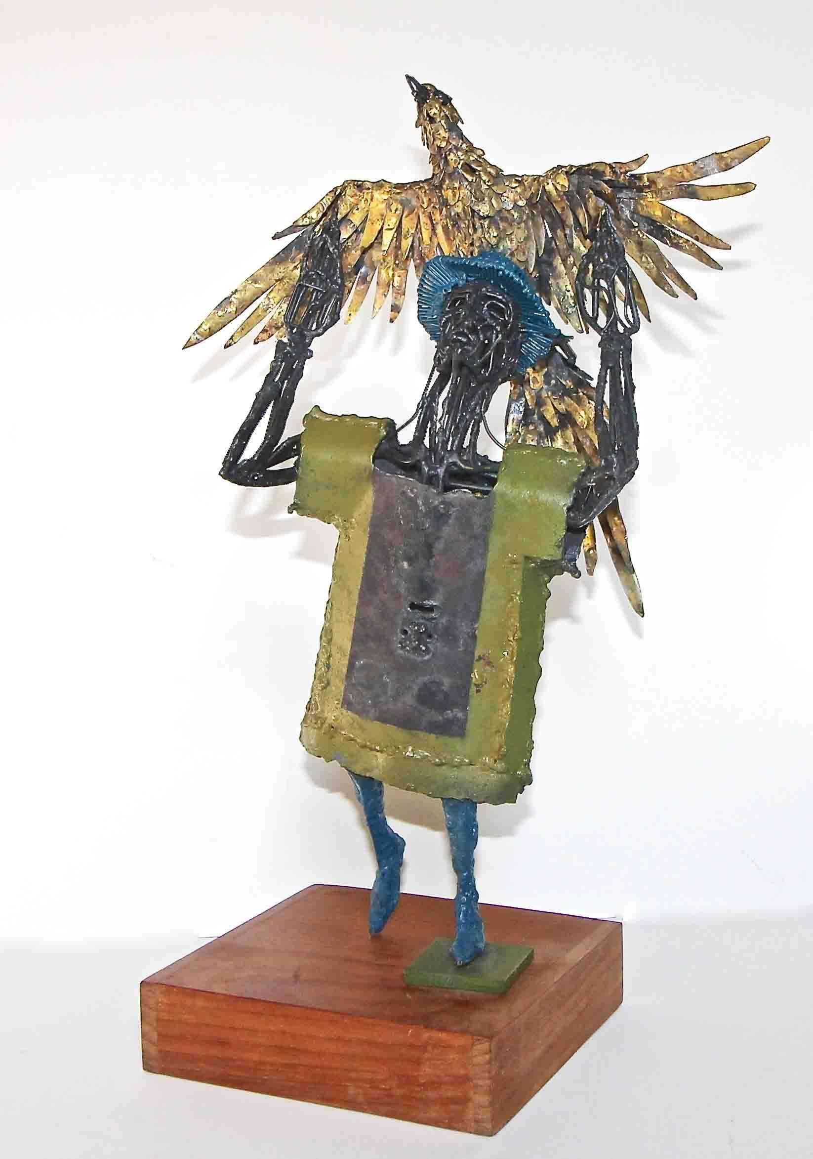 Original metal sculptor of man holding eagle mounted on wood base by renown Texas artist and sculptor, Bob Fowler (1931-2010). Engraved on top of base initials 