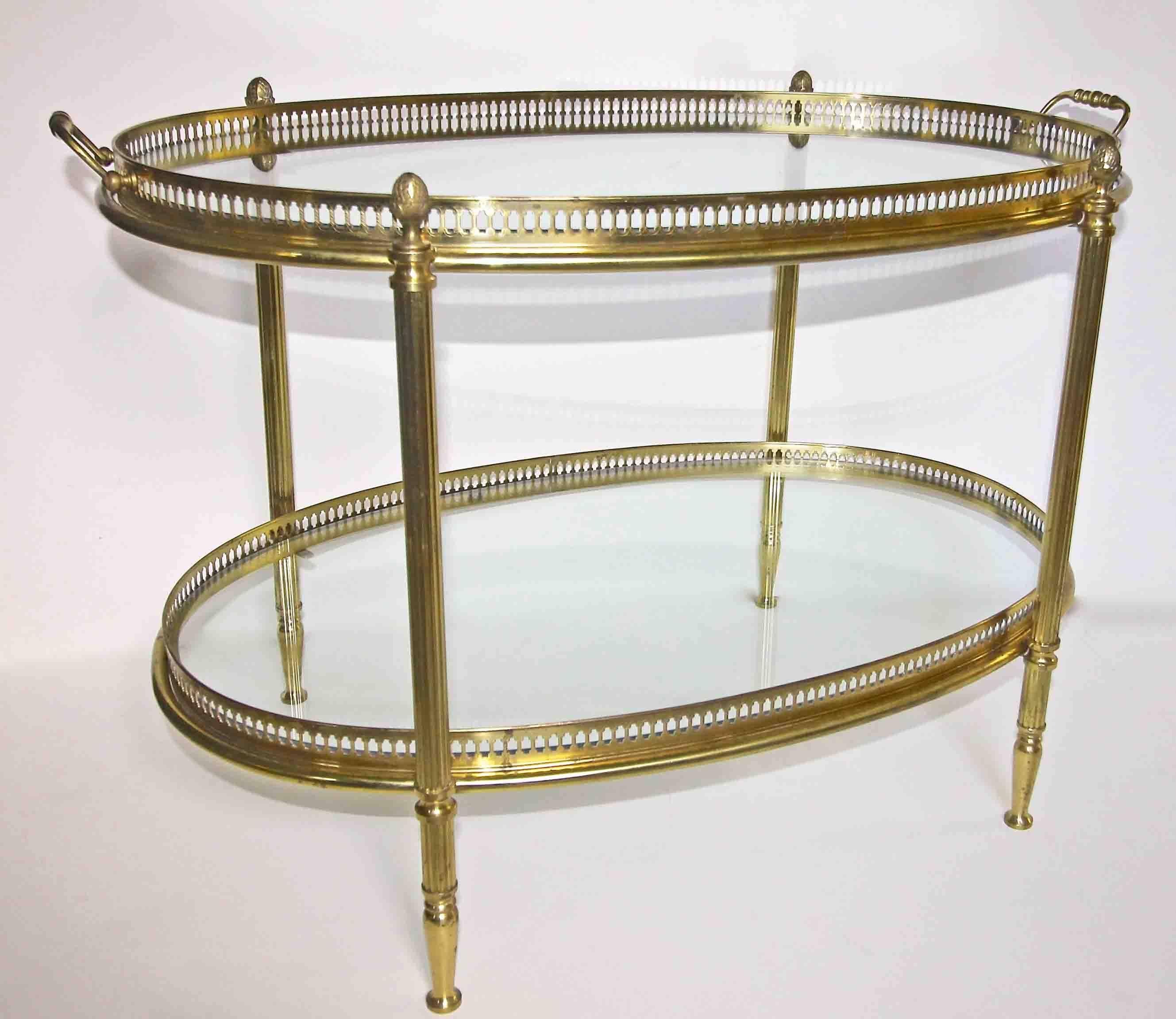 Oval two-tier brass French side table or tea table with removable glass inset tray at top. Nice detailing including reeded legs, pierced gallery railing and acorn finials.
