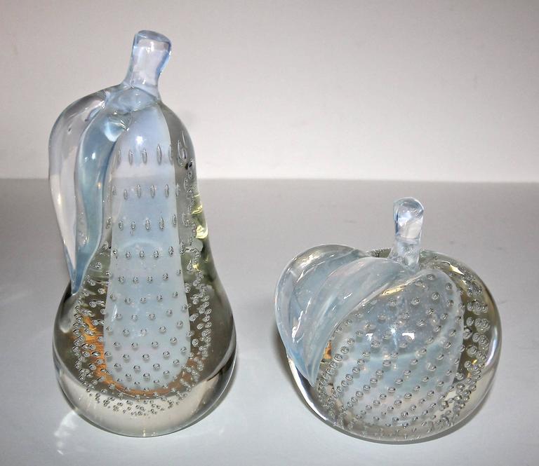 Pair of large handblown apple and pear fruit art glass book ends By Salviati. Glass is combination clear with control bubbles and opalescent. Each has Salviati sticker. 

Pear 8.5" H X 4" W.
Apple 5.75" H x 5.5" W.