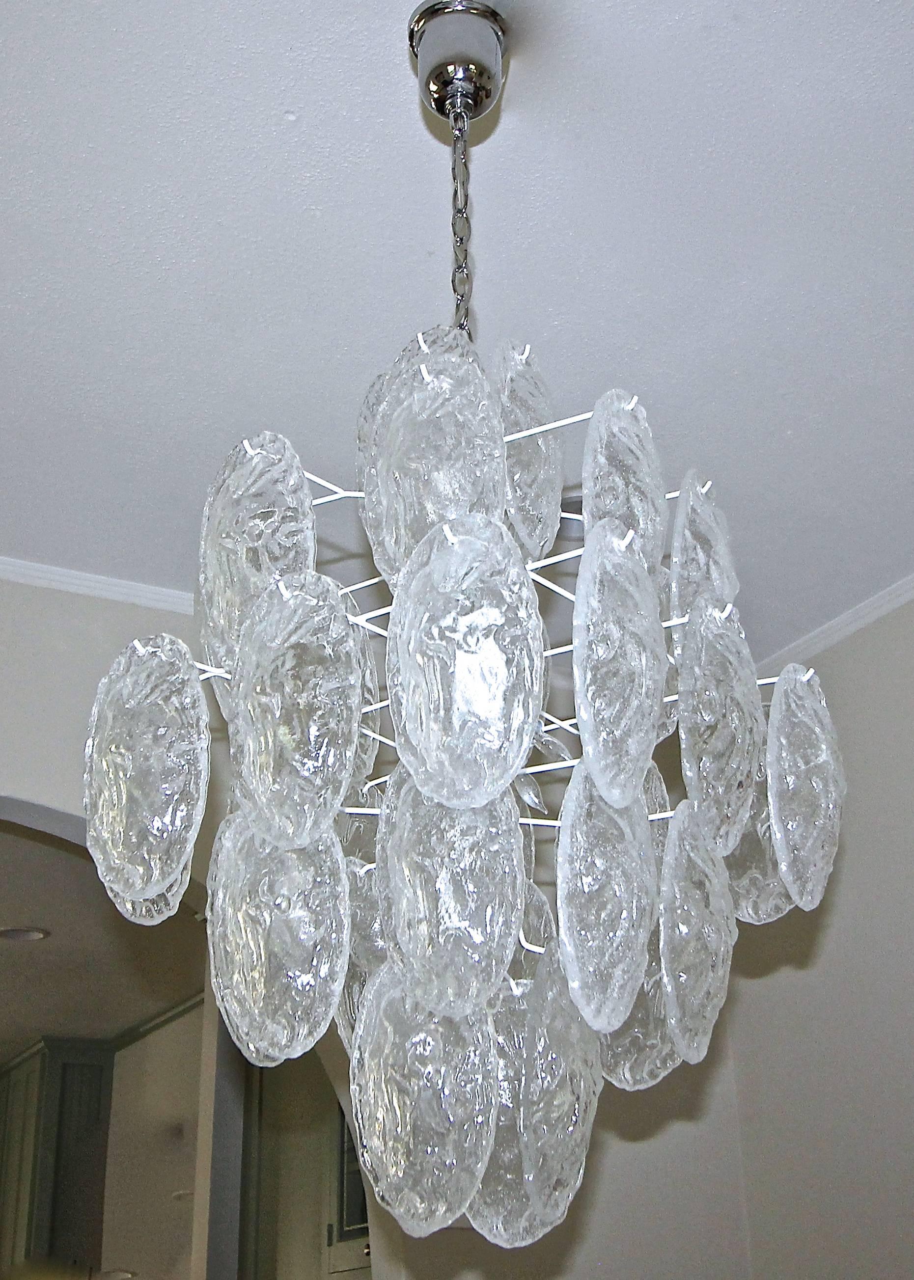 Murano chandelier with textured oval glass discs suspended on a metal frame in a white painted finish. Newly wired for US, fixture uses eight candelabra base bulbs.

Height of chandelier is 29 " X 24.5 " diameter (measured on the