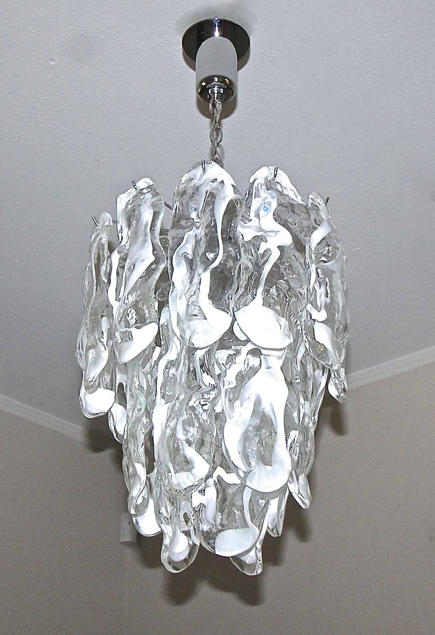 Murano glass chandelier by Mazzega with handblown clear and white undulating glass panels. Newly chrome-plated frame with five candelabra "B" base bulbs, newly wired for US. A later 4.5" diameter chrome-plated backplate has been added