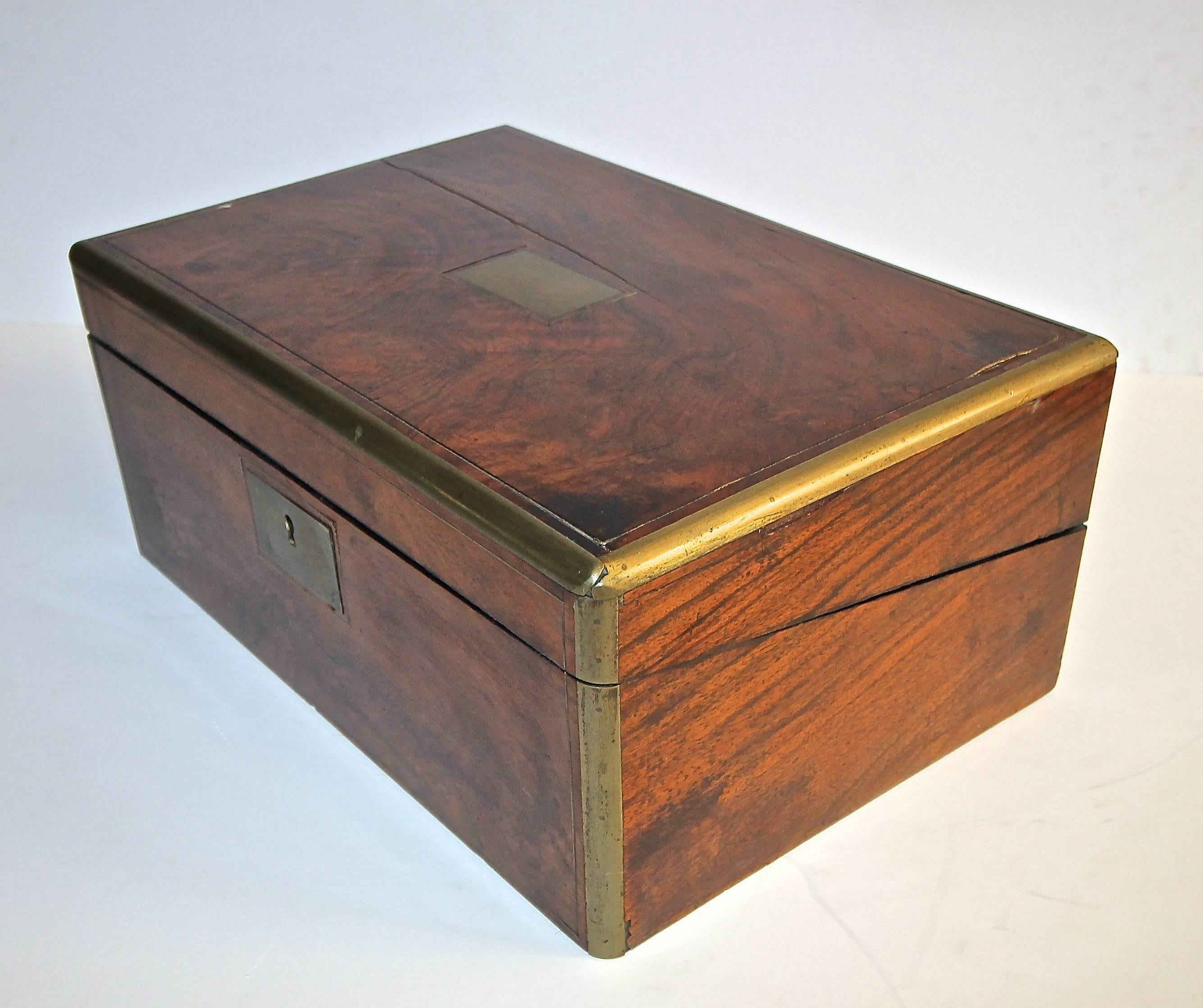 19th century English mahogany and brass writing box with leather writing top and storage compartments.