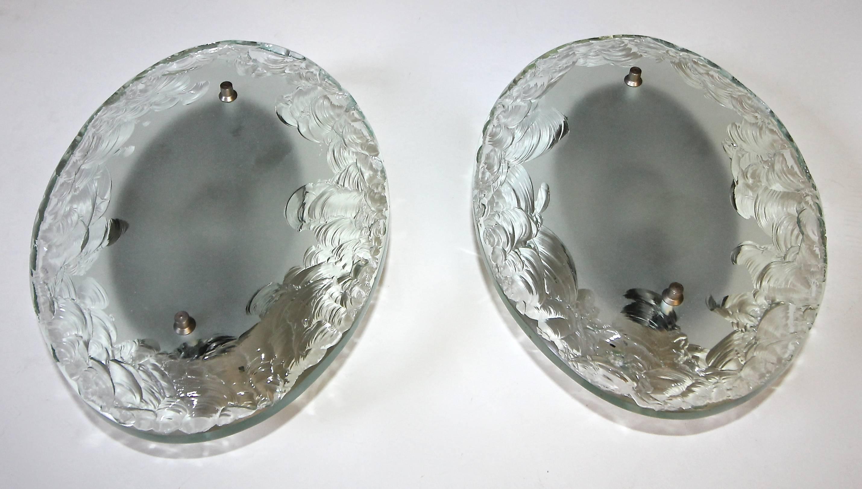 Pair of rare Italian thick oval "broken glass" technique wall sconces in the style of Fontana Arte. Each sconce uses a single candelabra B base bulb. Newly wired for US.