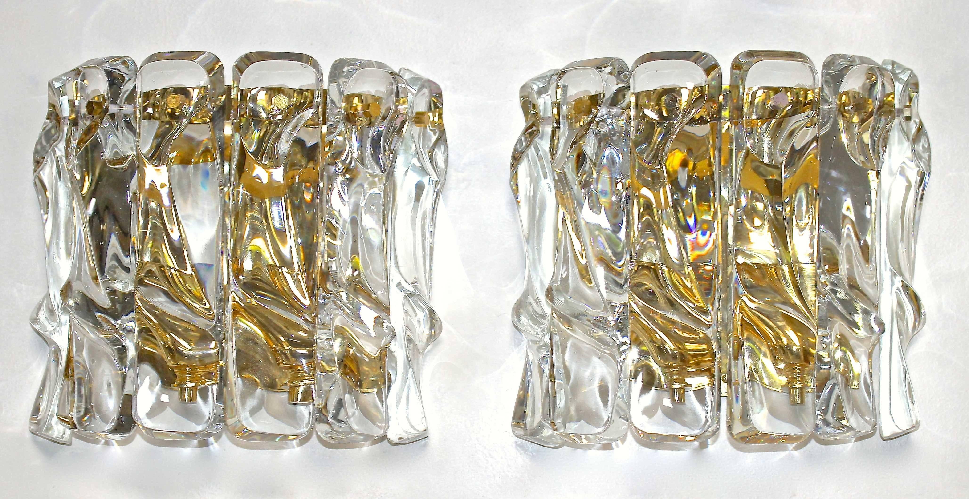 Set of four, two-light wall sconces with thick ice shaped crystals on gold-plated metal backplates. Each sconce uses two candelabra base bulbs. Newly wired for US.