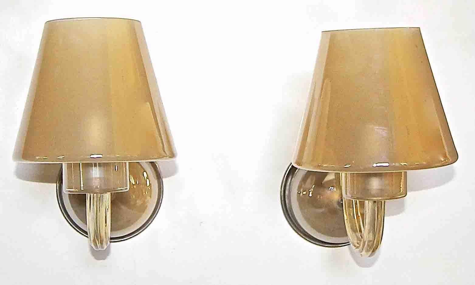 Pair of Murano glass single arm wall sconces in gold champagne color with glass shades. Exterior of glass has a slight opalescent appearance and interior is acid etched. Each sconce uses one regular size A base bulb. Newly wired for US.