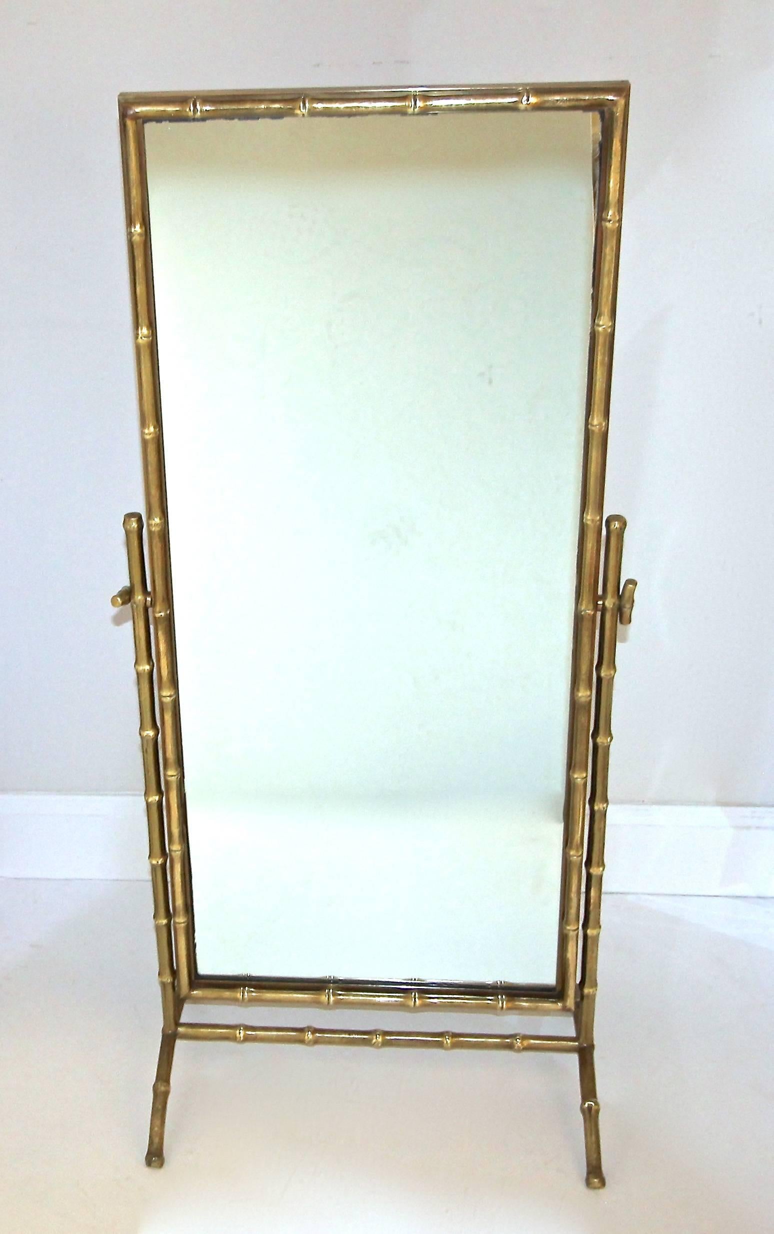 Rare French faux bronze bamboo cheval floor or dresser mirror, attributed to Maison Bagues. Framed mirror pivots with smart bamboo handles at side.