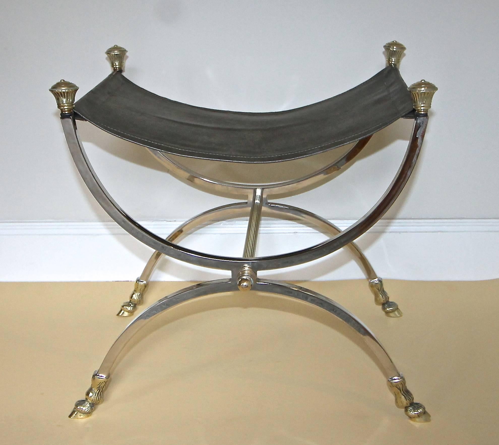 French directoire style nickelled steel and brass bench or stool with green leather seat. Nice detail including hoof feet legs and heavy thick cast brass finials.