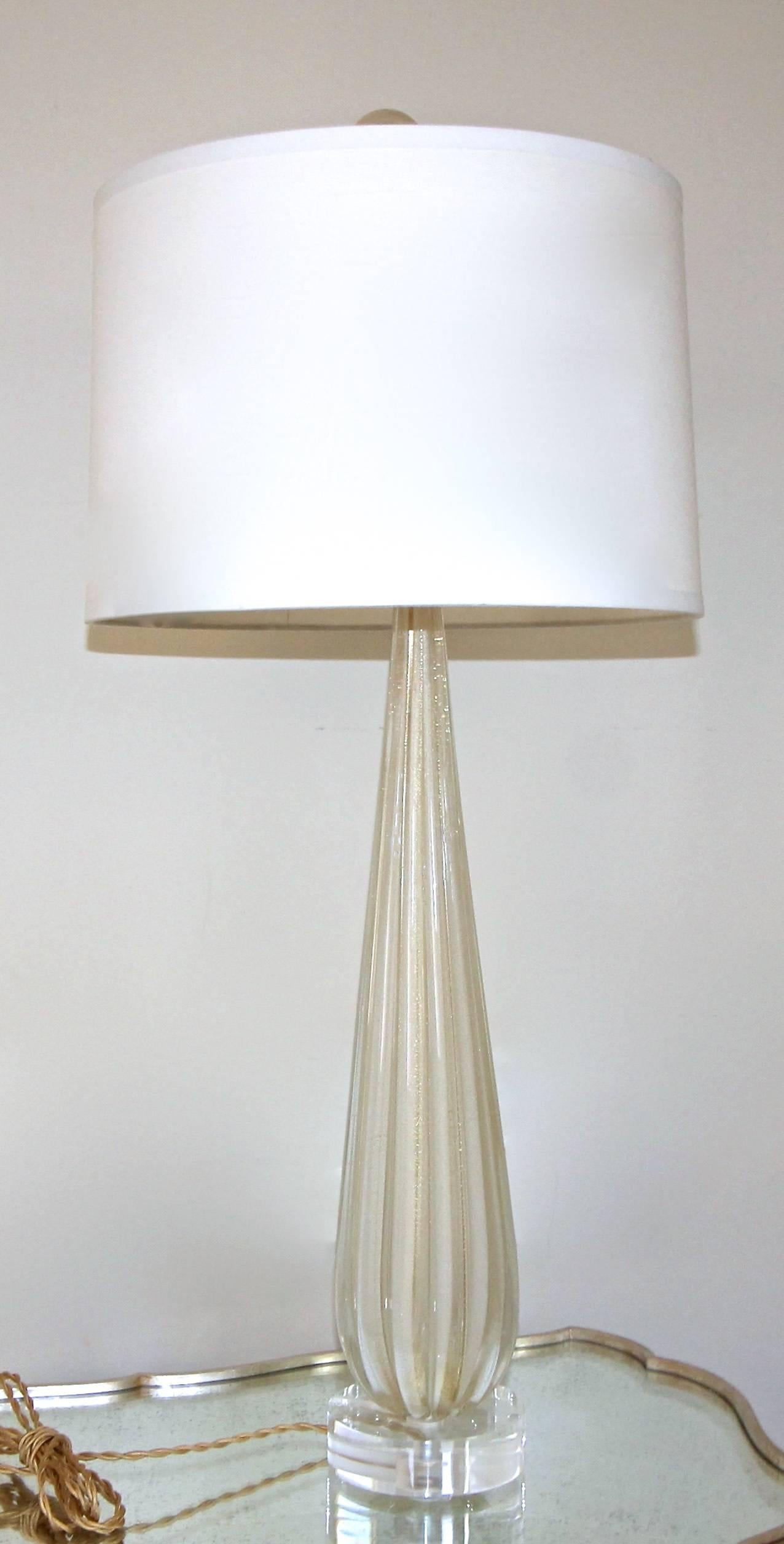 Tall slender shaped Murano Venetian handblown cased ribbed glass lamp in white with gold inclusions by Barbini. Newly wired for the US on a custom acrylic base brass fittings, full range dimmer socket and French style twisted rayon covered cords.