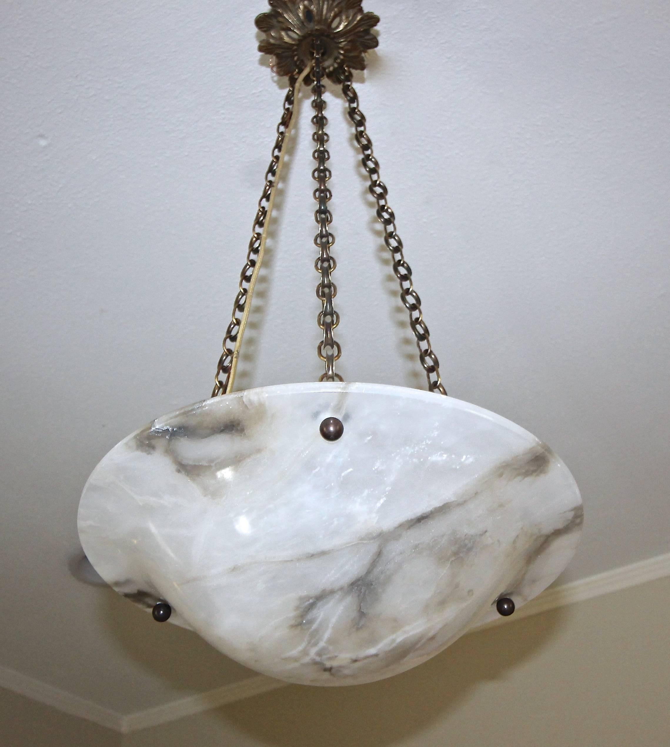 French Louis XV style alabaster pendant or ceiling light with a semi translucent white alabaster bowl with grey veining. Fixture has decorative bronze fittings and ceiling cap. Fixture uses one regular size A or Edison base bulb. Newly wired for