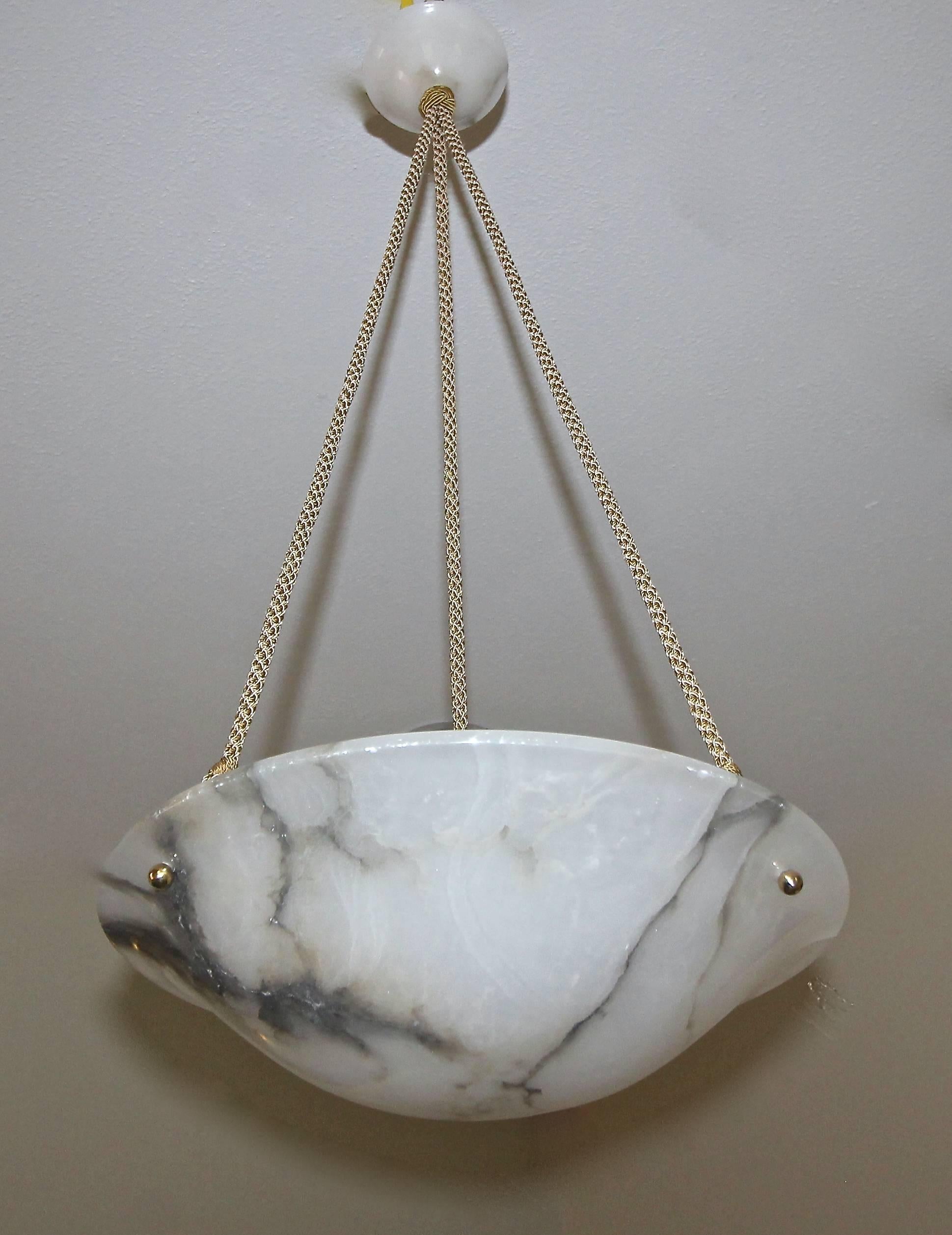 French alabaster pendant light or chandelier, suspended on newer decorative rayon covered cords. The white semi translucent alabaster has abundance of beautiful grey veining. Fixture uses three candelabra B base bulb and is newly wired for US.