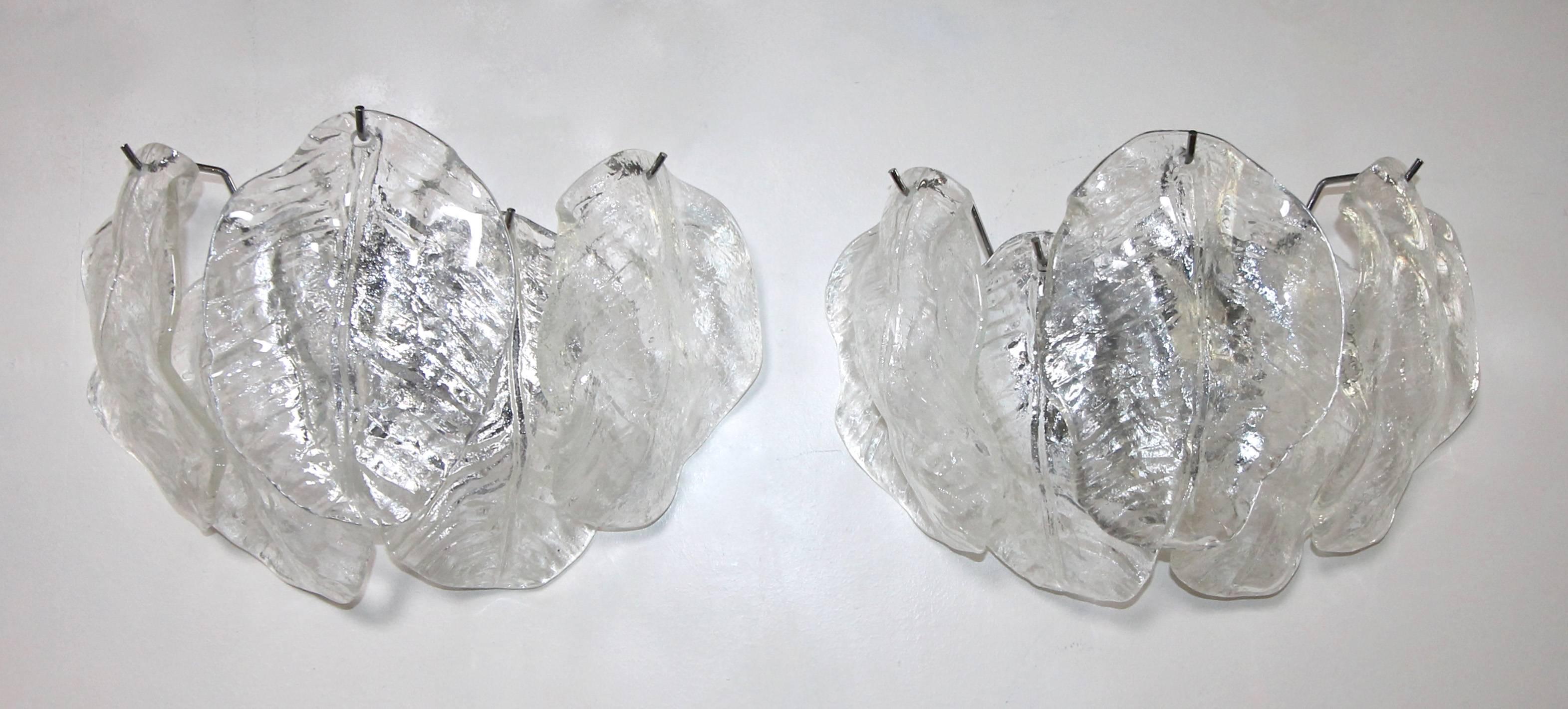 Two Pairs (4 total) of Italian Murano clear textured glass leaf wall sconces with nickel plated steel backplates, attributed to Mazzega. Rewired for US, each fixture uses two candelabra a base  bulbs. 
Measures: 13.5