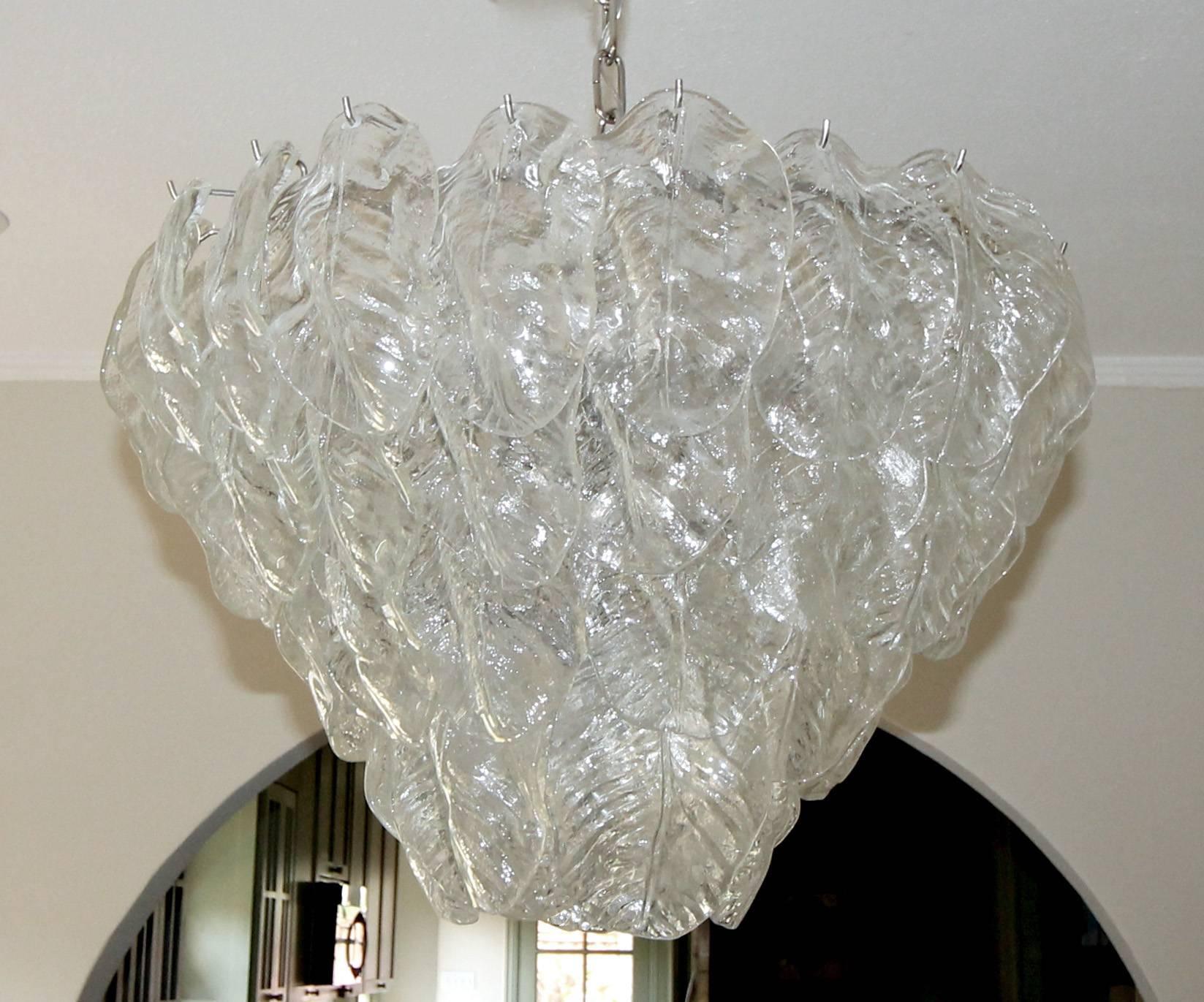 Large Murano Italian textured glass leaf chandelier, attributed to Mazzega. Clear handblown glass leaves suspended on steel frame. Fixture is rewired for US and uses five regular size A or Edison base bulbs. Matching pair of sconces under separate