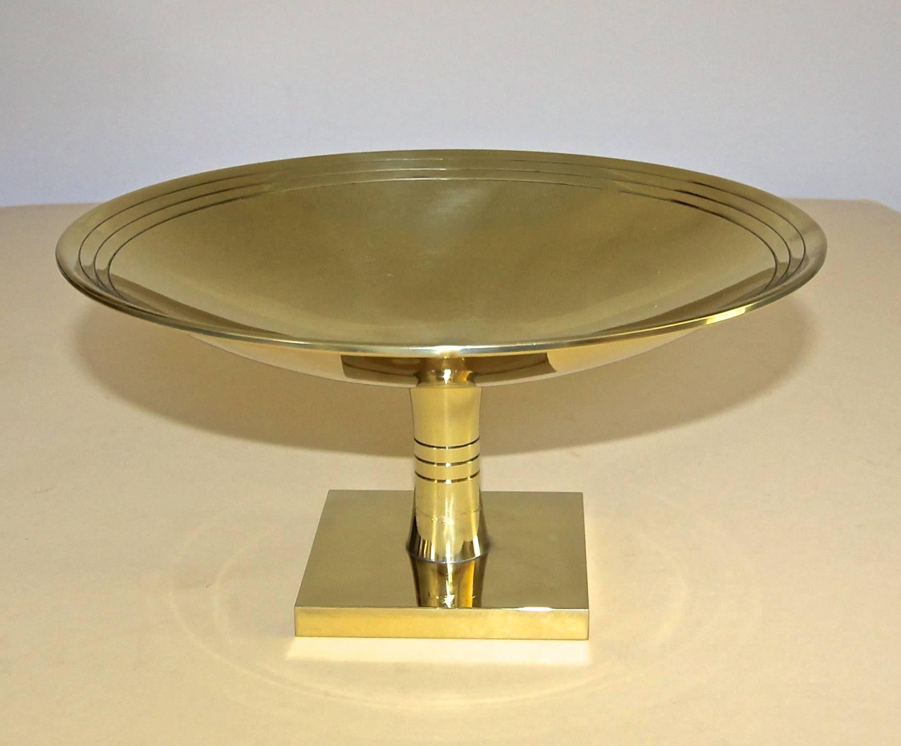 Large round footed brass compote by Tommi Parzinger for by Vincent Lippe / Dorlyn Silversmiths, New York. Each element of the Dorlyn accessories was hand crafted from sheet brass in New York. Stamped Dorlyn Silversmiths. The compote has been more