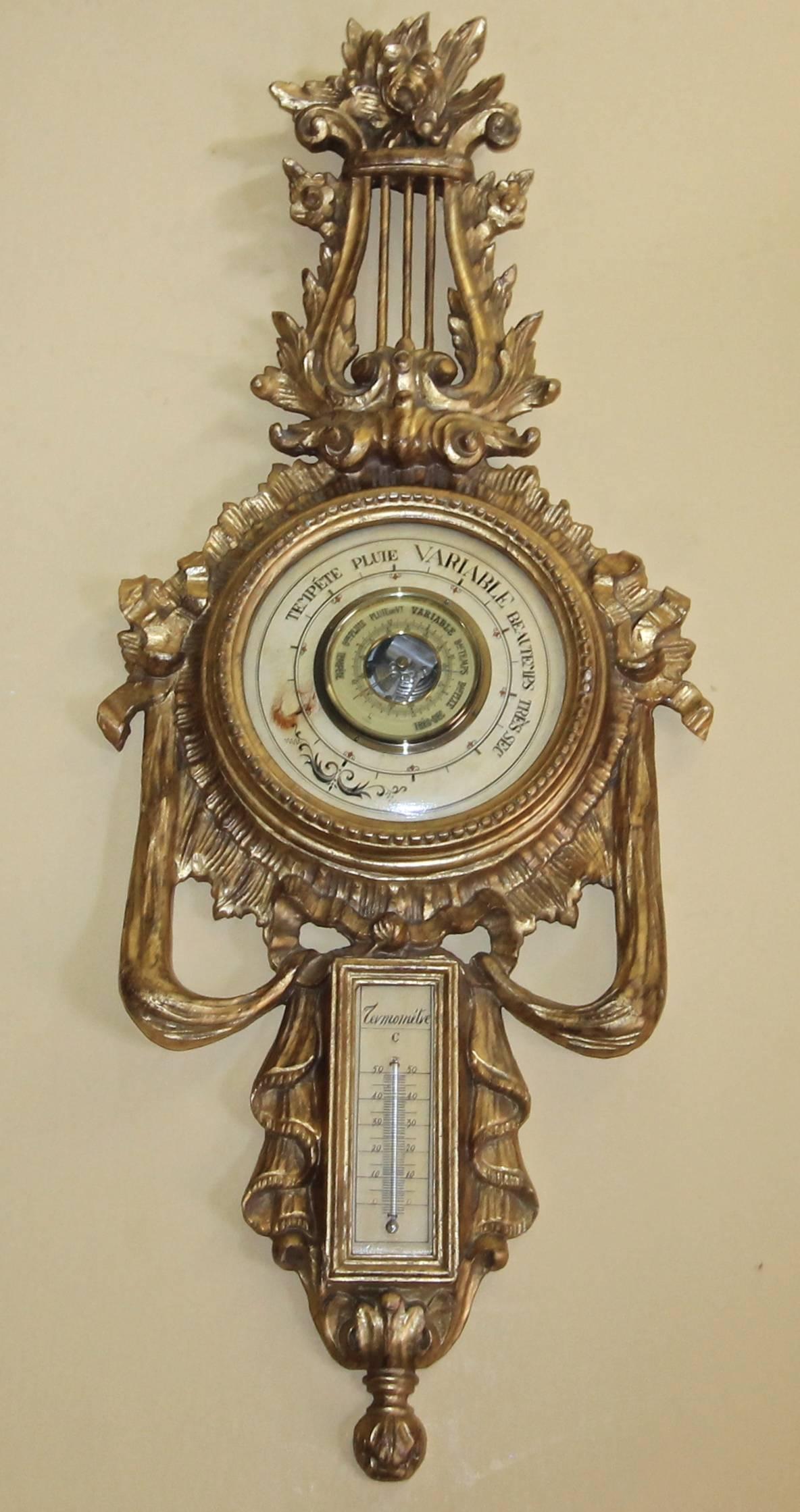 Giltwood carved Italian wall barometer and thermometer combination in the neoclassical style. For decorative use only as the barometer and thermometer do not appear to work.