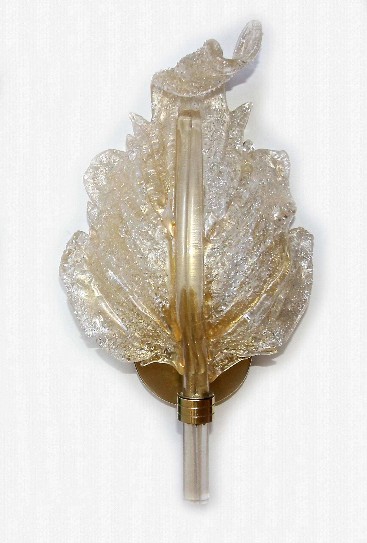 Single (one) handblown Barovier glass leaf wall sconce in in clear with heavy gold inclusions. Rugiodoso technique to back of leaf with scattered particles of glass to help diffuse light. Supported on brass backplate, fixture uses one candelabra