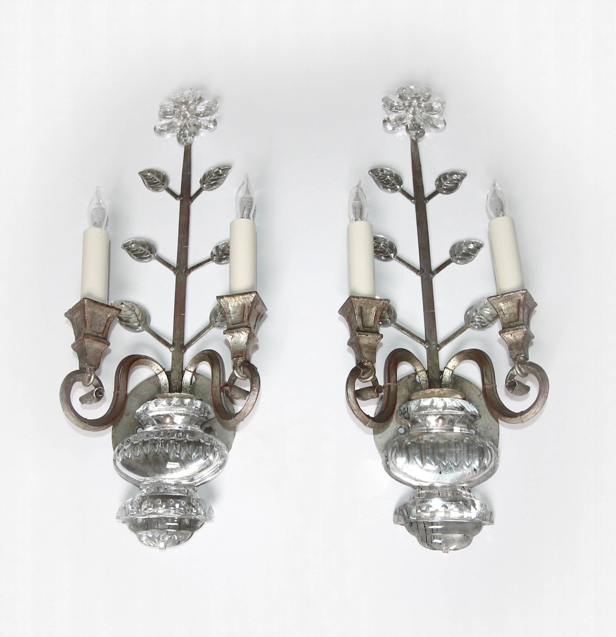 Pair of silver gilt iron floral sconces in the style of Maison Baguès with crystal leaves and urn motif. Each sconce uses two candelabra base bulbs. Newly rewired for US.