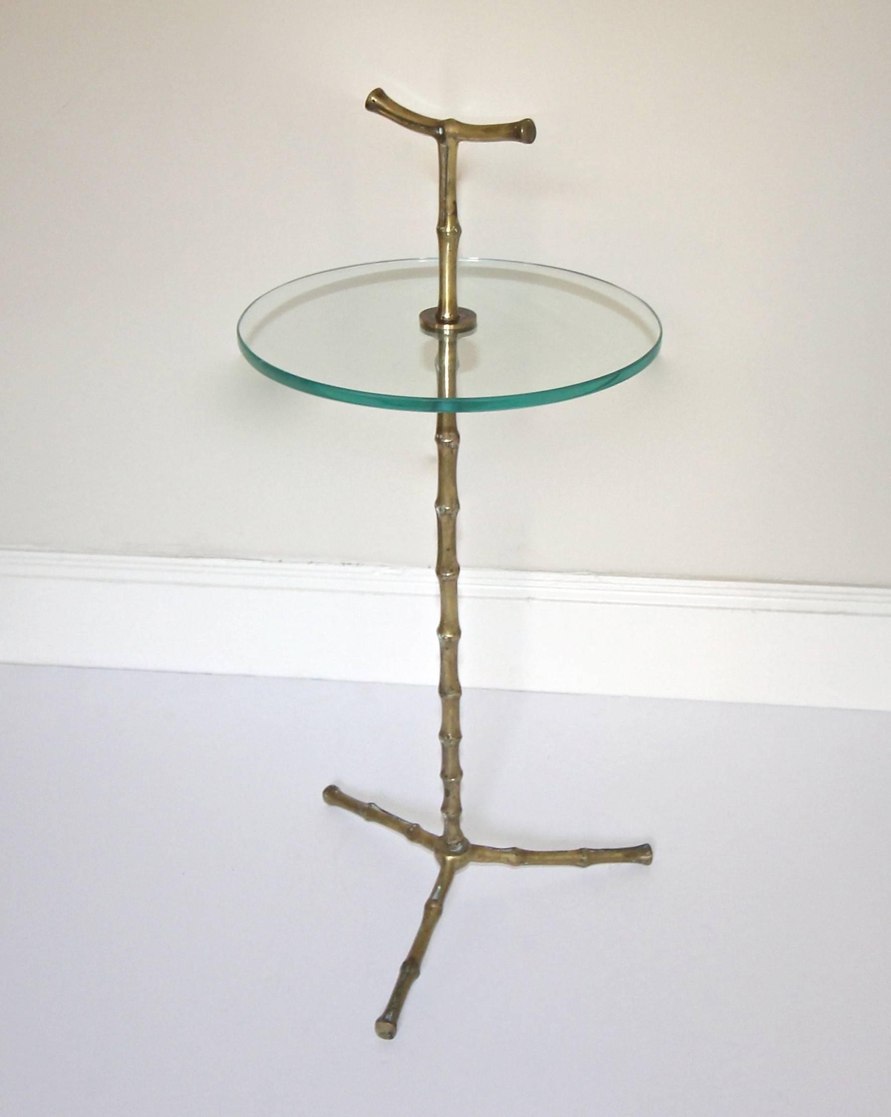 Maison Baguès faux-bamboo bronze or brass side table with a circular glass top and tripod base.
Measures: Height top of glass 19", over all height top of handle 24",
diameter of glass 11".
