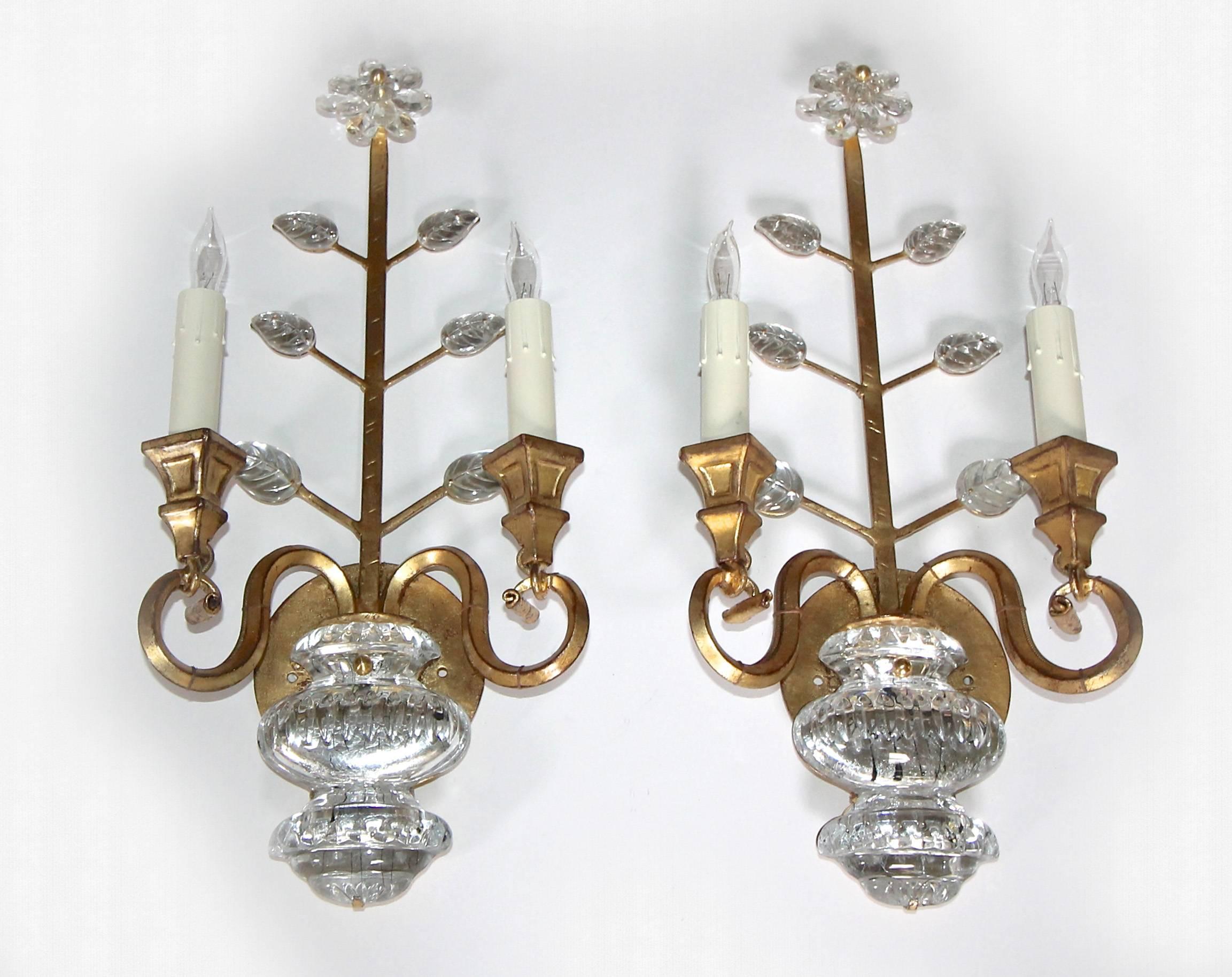 Pair of gilt iron floral sconces in the style of Maison Baguès with crystal leaves and urn motif. Each sconce uses two candelabra base bulbs. Newly rewired for US with backplate for US installation.

Measures: 18.25