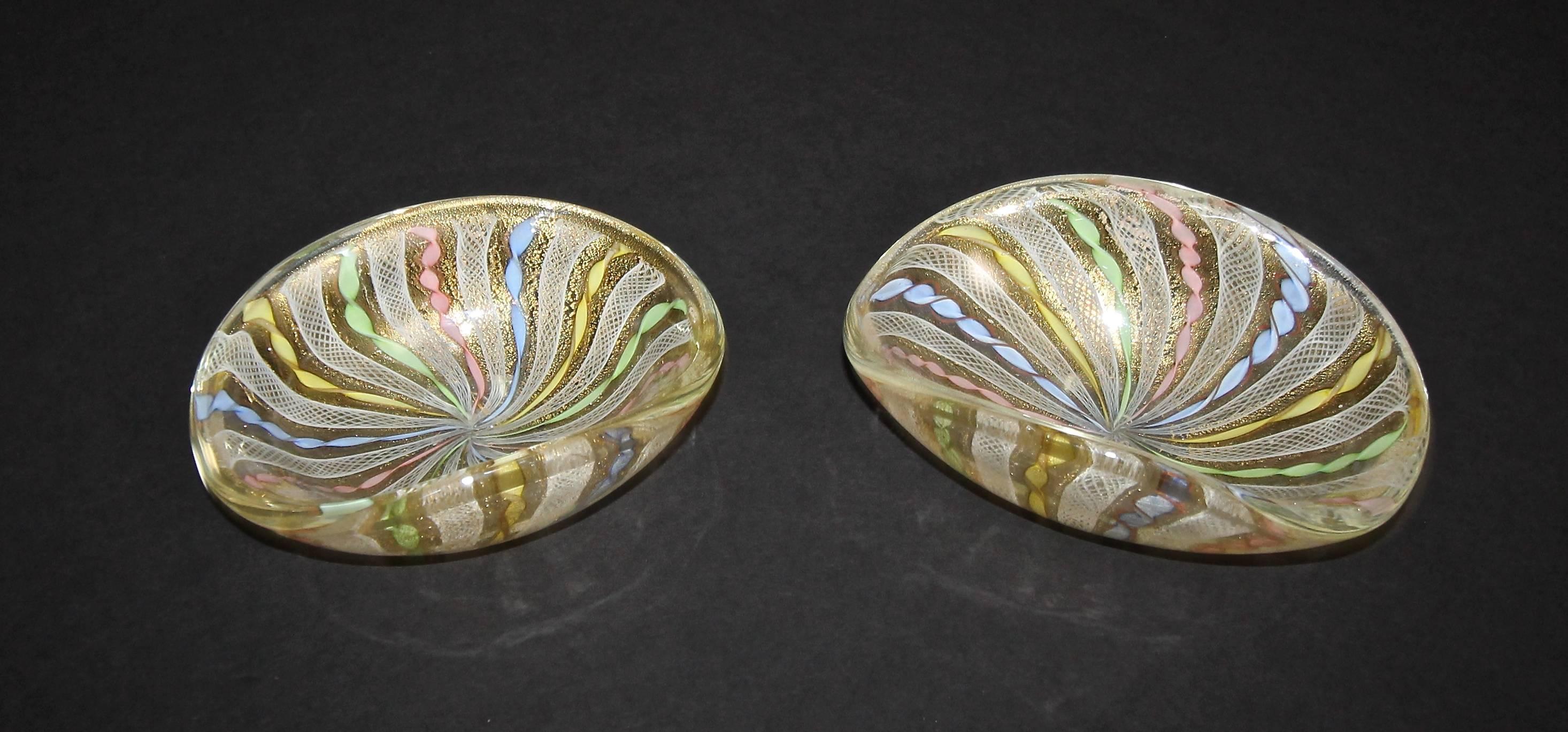 Pair of Murano Italian latticino (ribbons) handblown glass oval shape bowls. Expertly crafted with assortment of colors and gold inclusions.